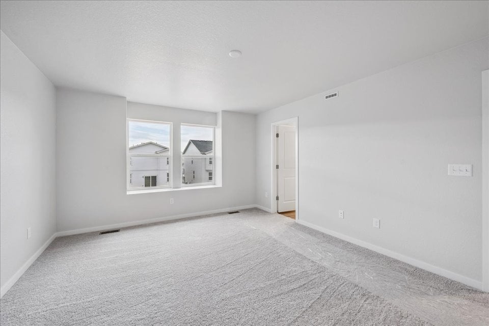 A room with a window and a carpet.