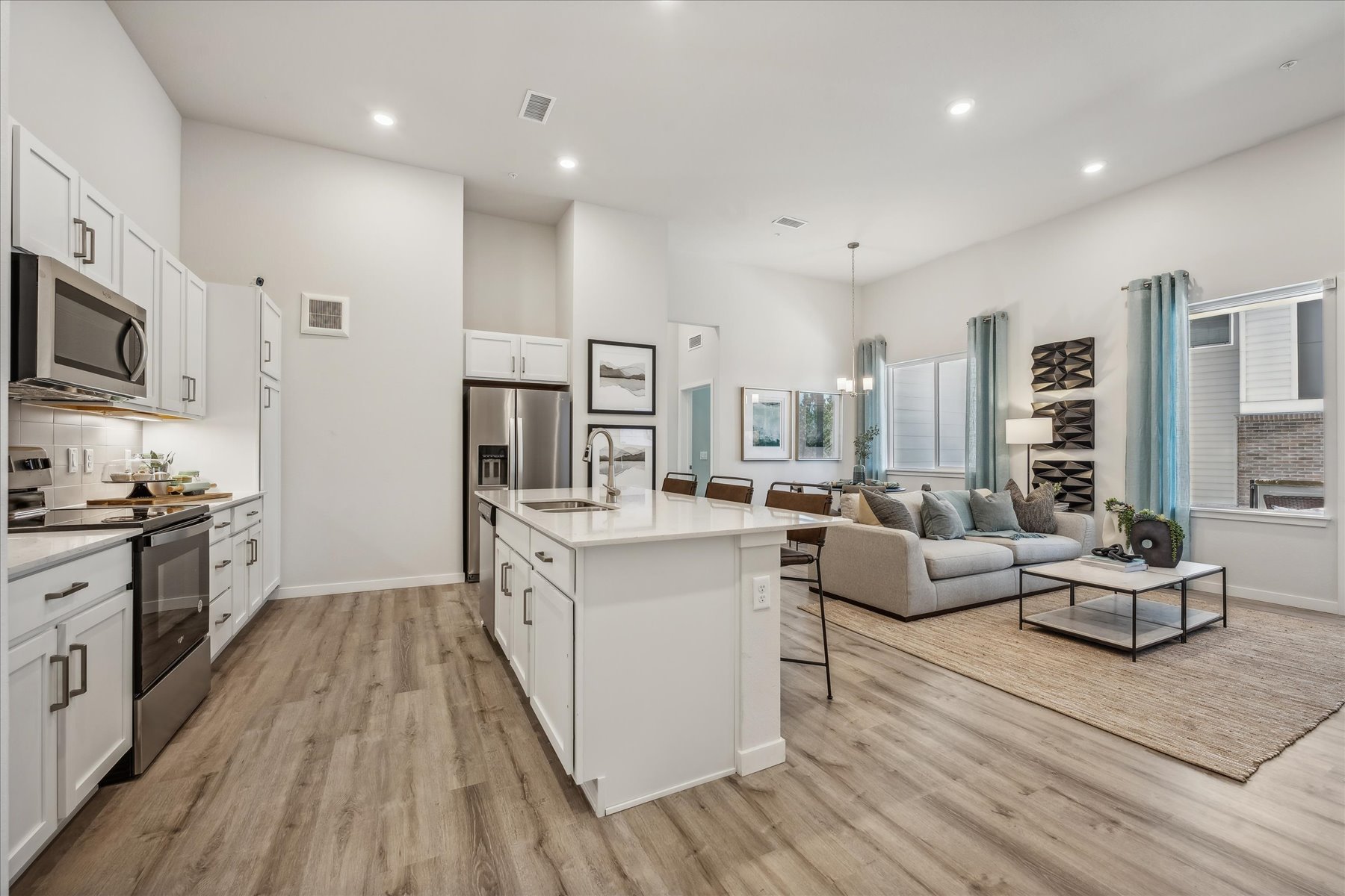 A large kitchen with a wood floor.