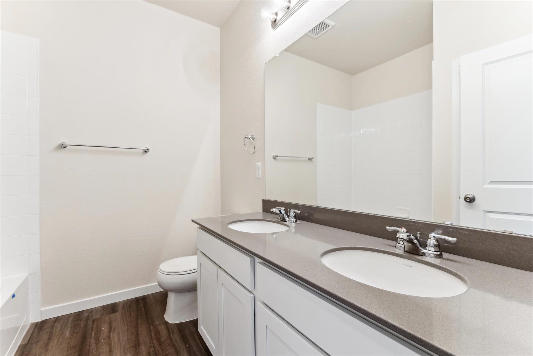 A bathroom with a large mirror.