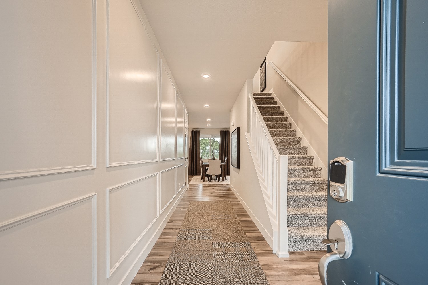 A hallway with a staircase.