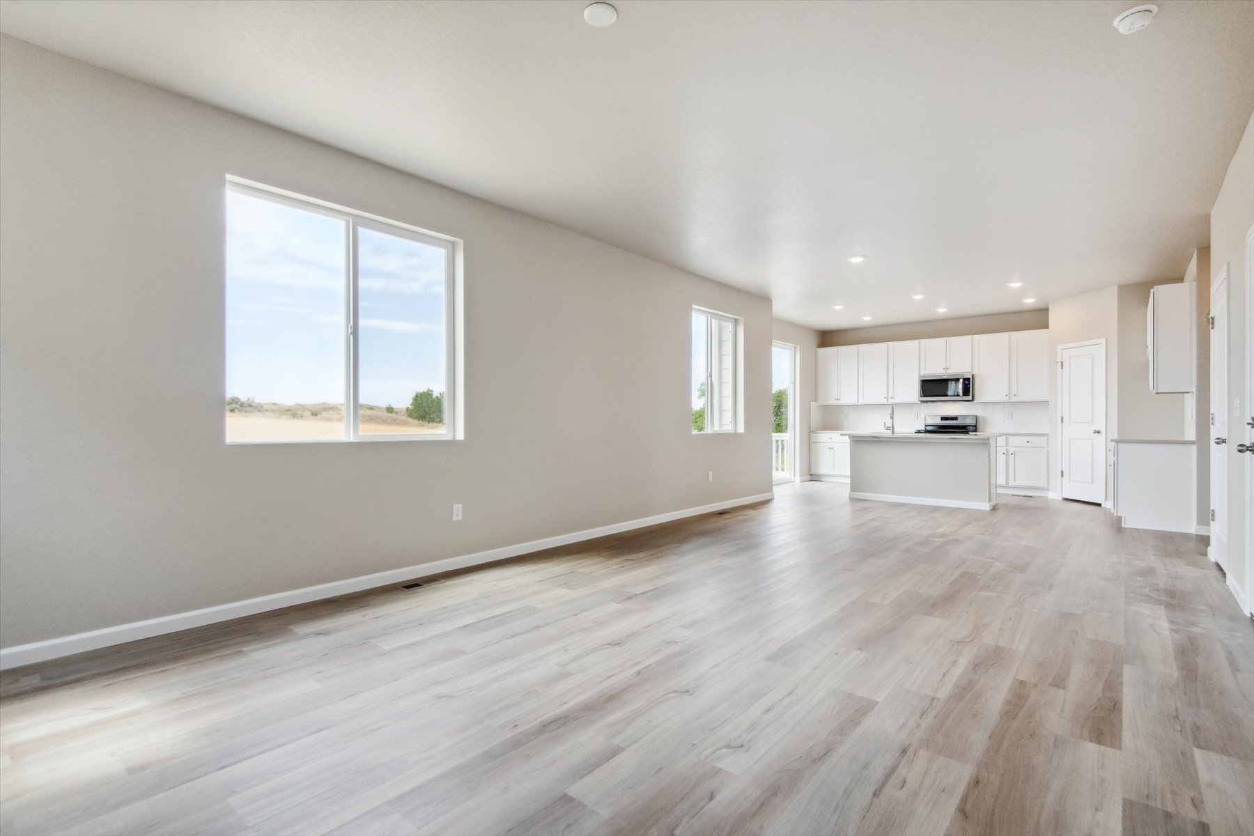 A large empty room with a wood floor.