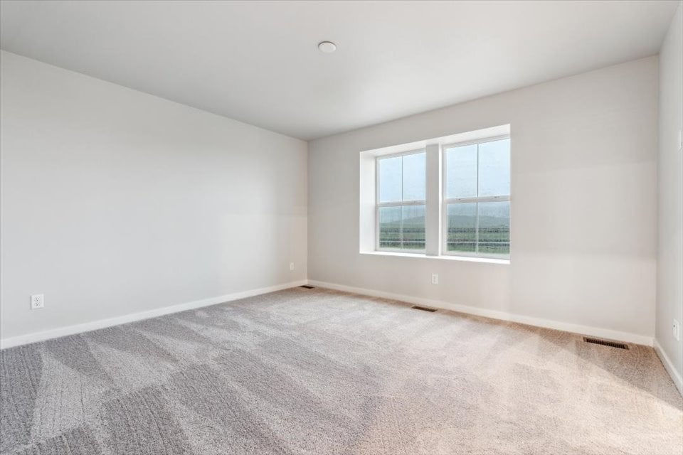 A room with a window and a carpet.