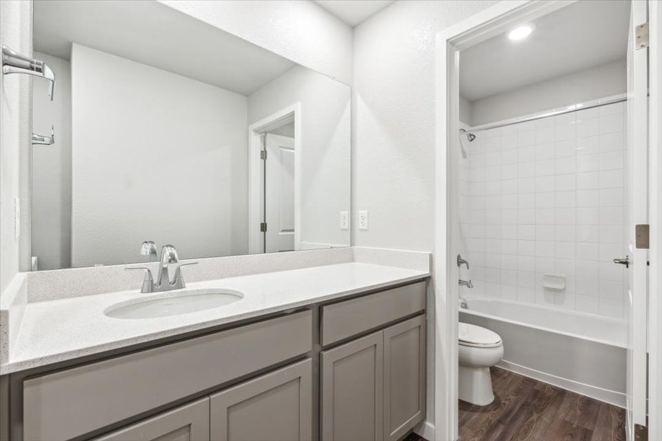 A bathroom with a sink and a toilet.