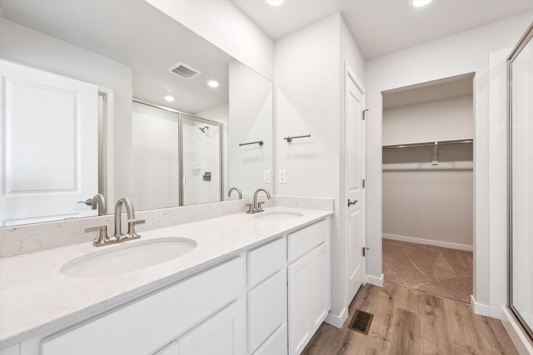 A bathroom with a large mirror.