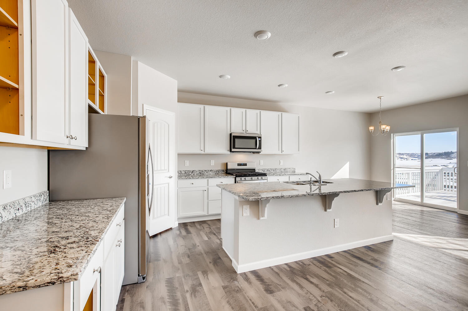 A kitchen with white cabinets.