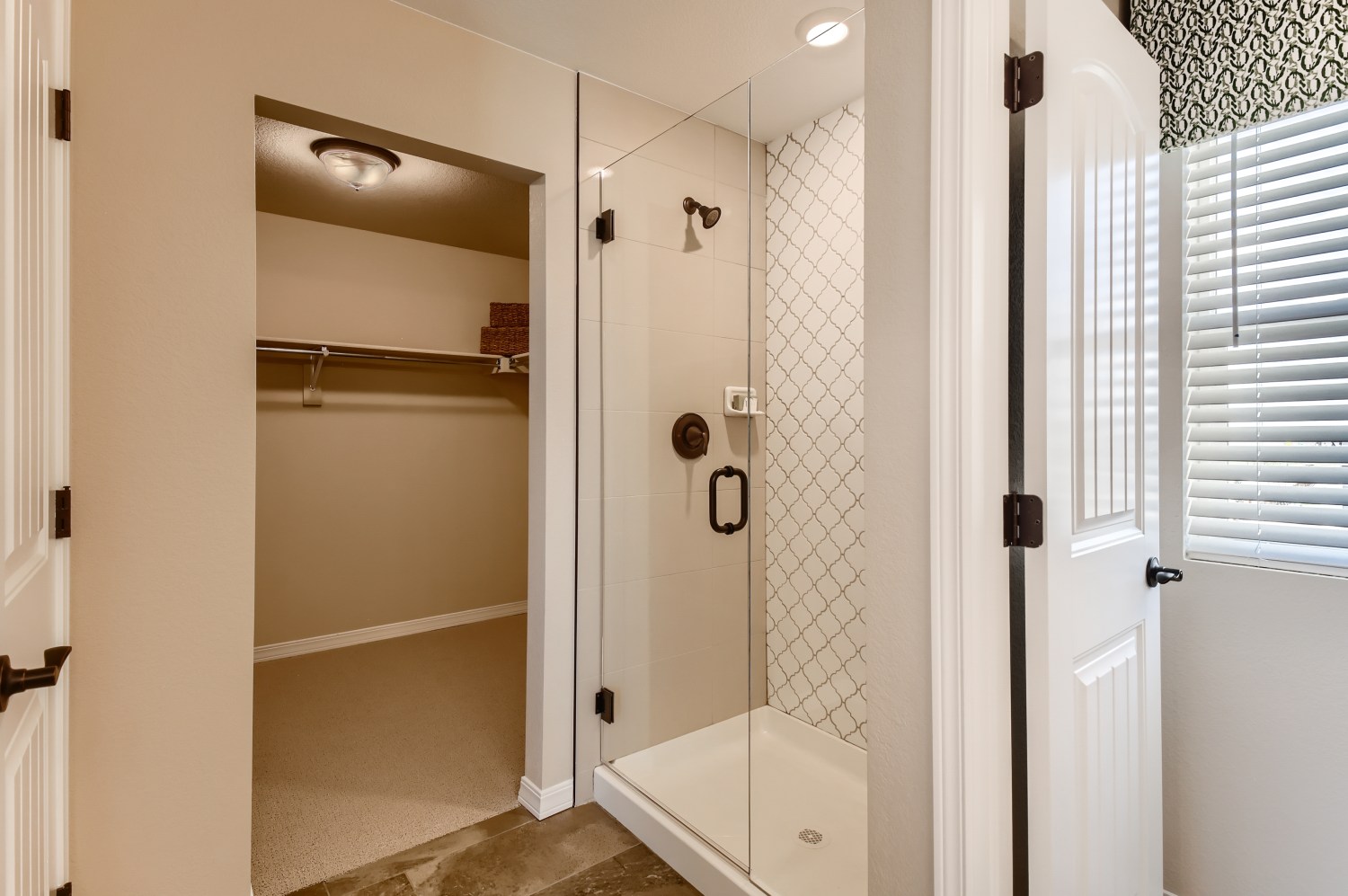 A bathroom with a shower unit and a bathtub.