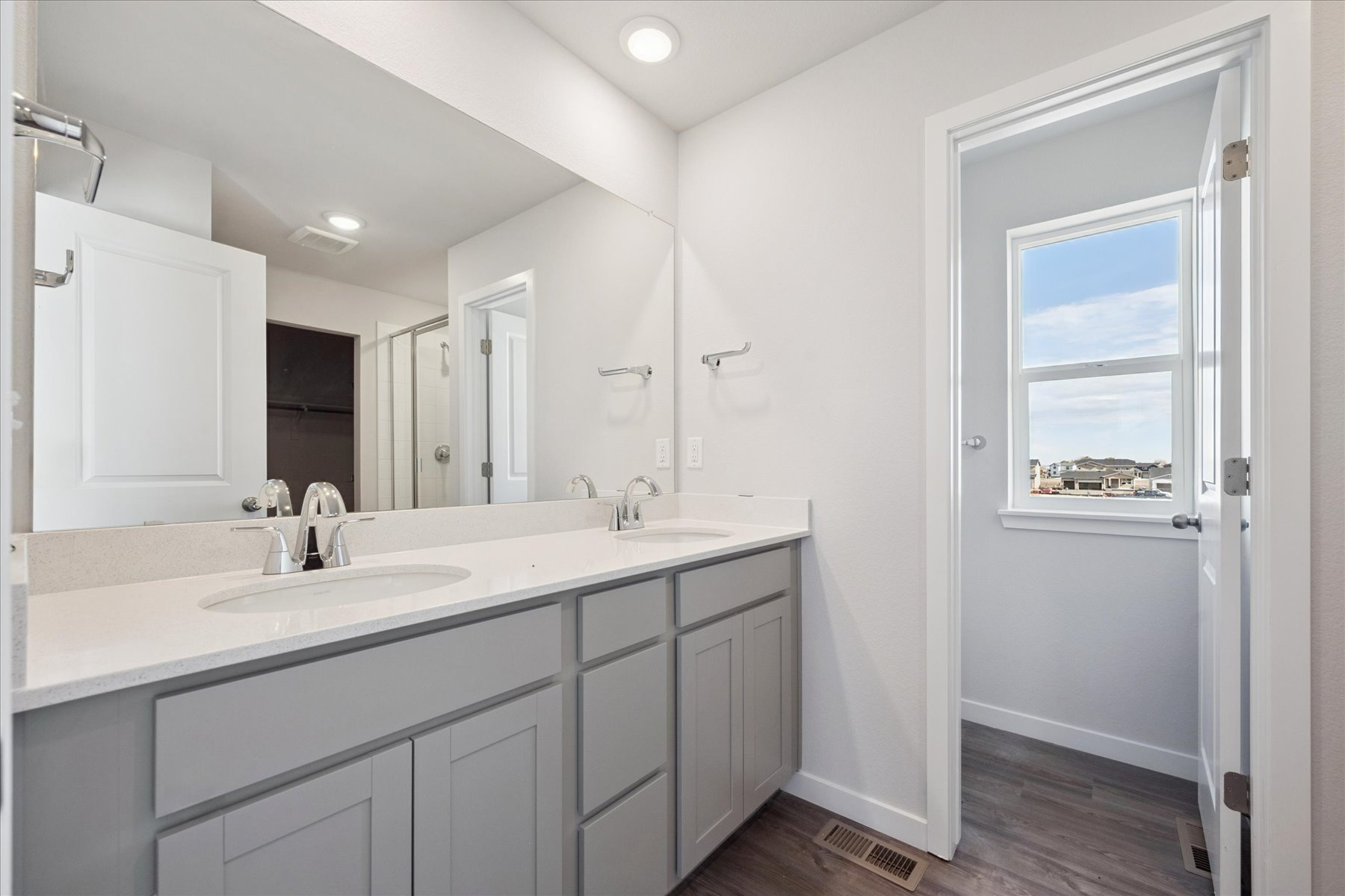 A bathroom with white cabinets.