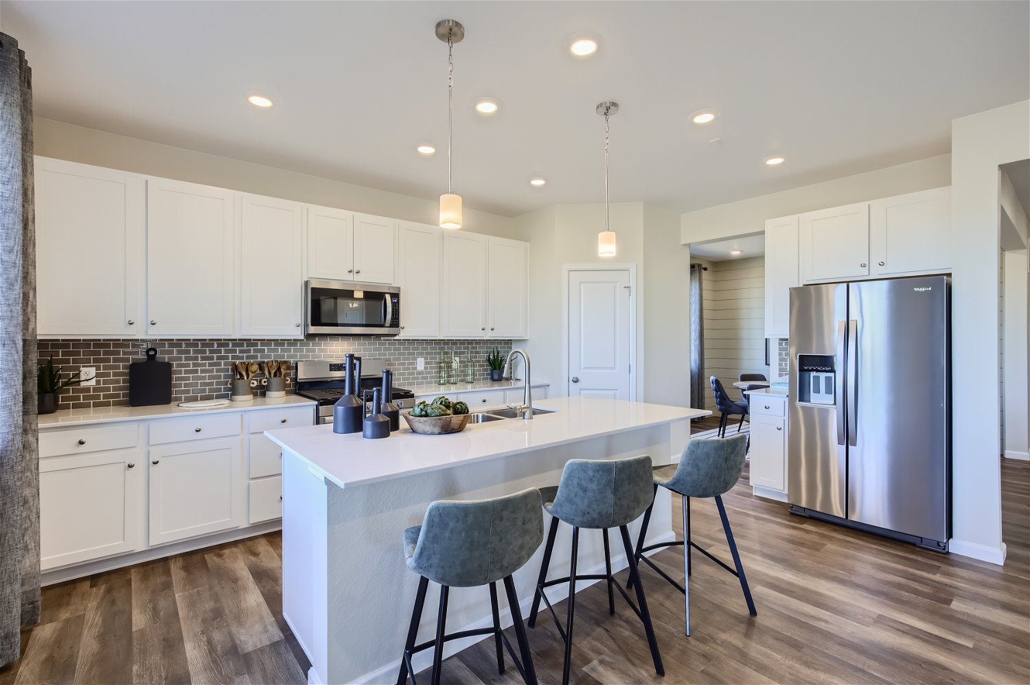 A kitchen with white cabinets.