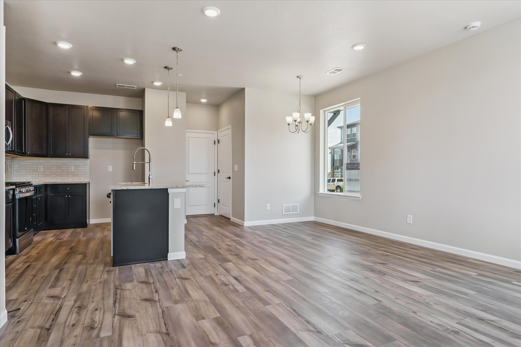 A kitchen with black cabinets.