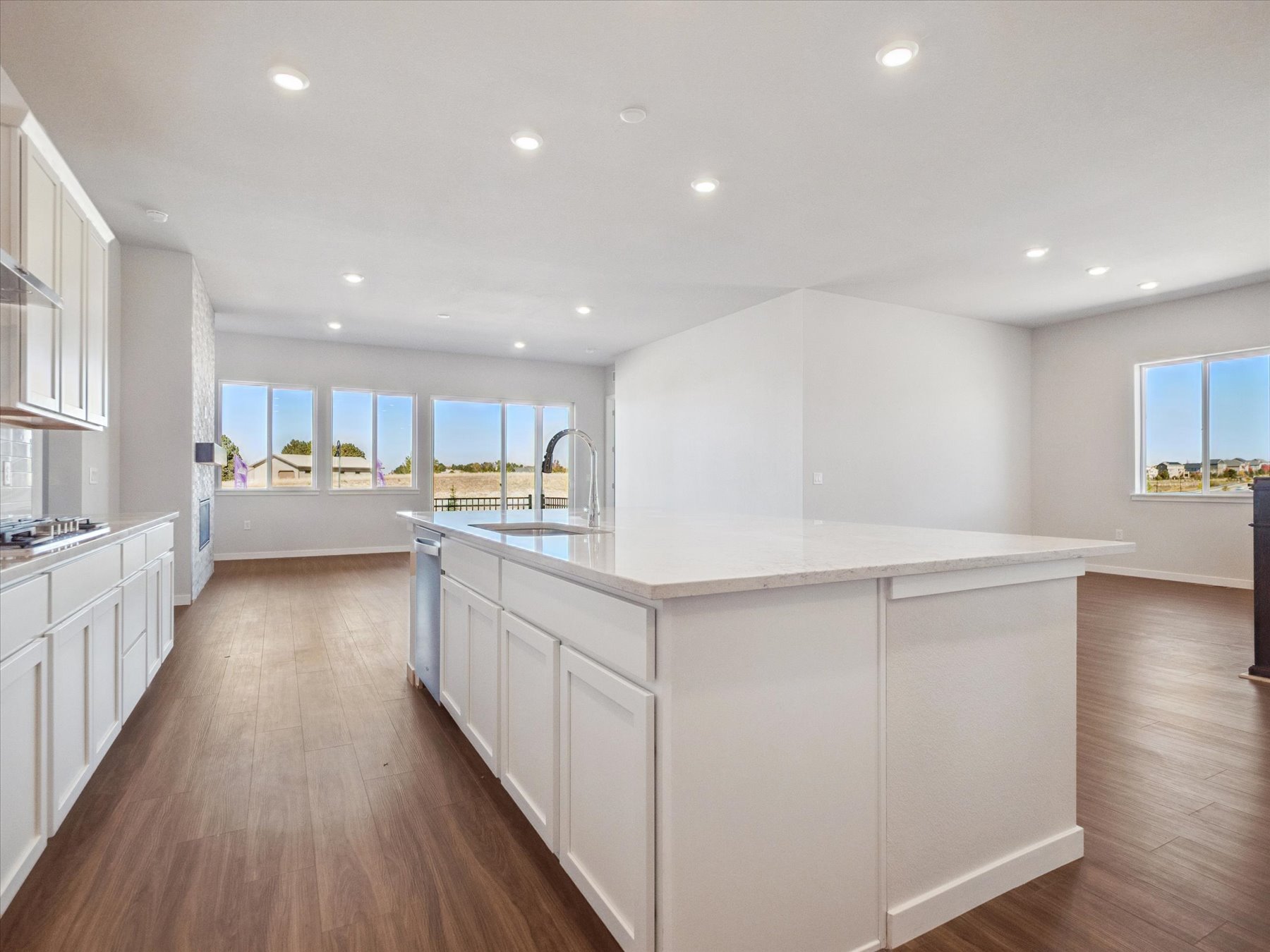 A kitchen with white cabinets.