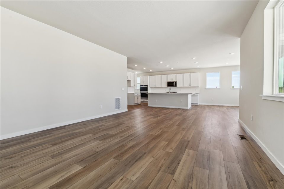 A room with a wood floor and white walls.