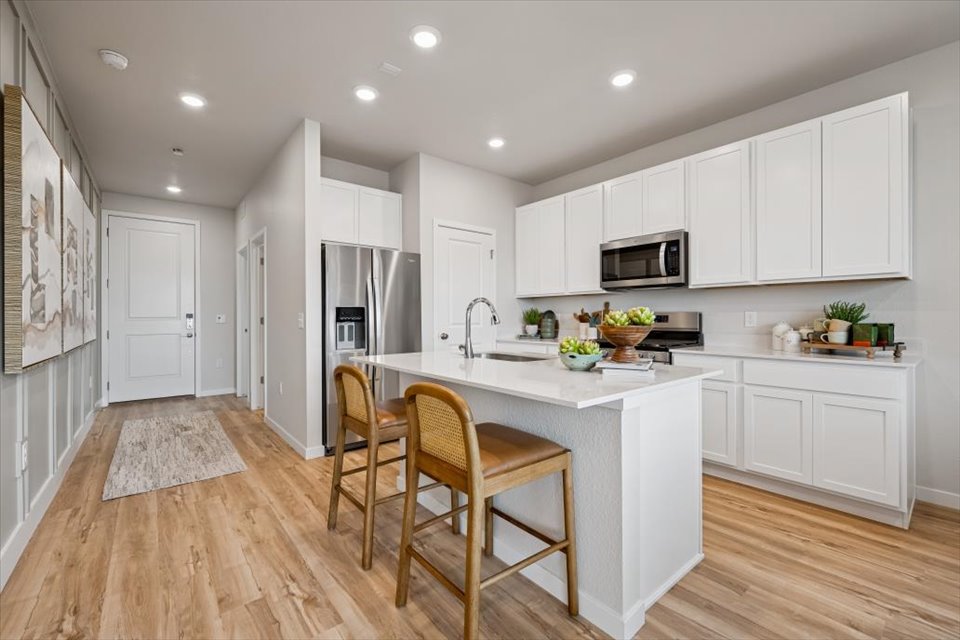 A kitchen with white cabinets.