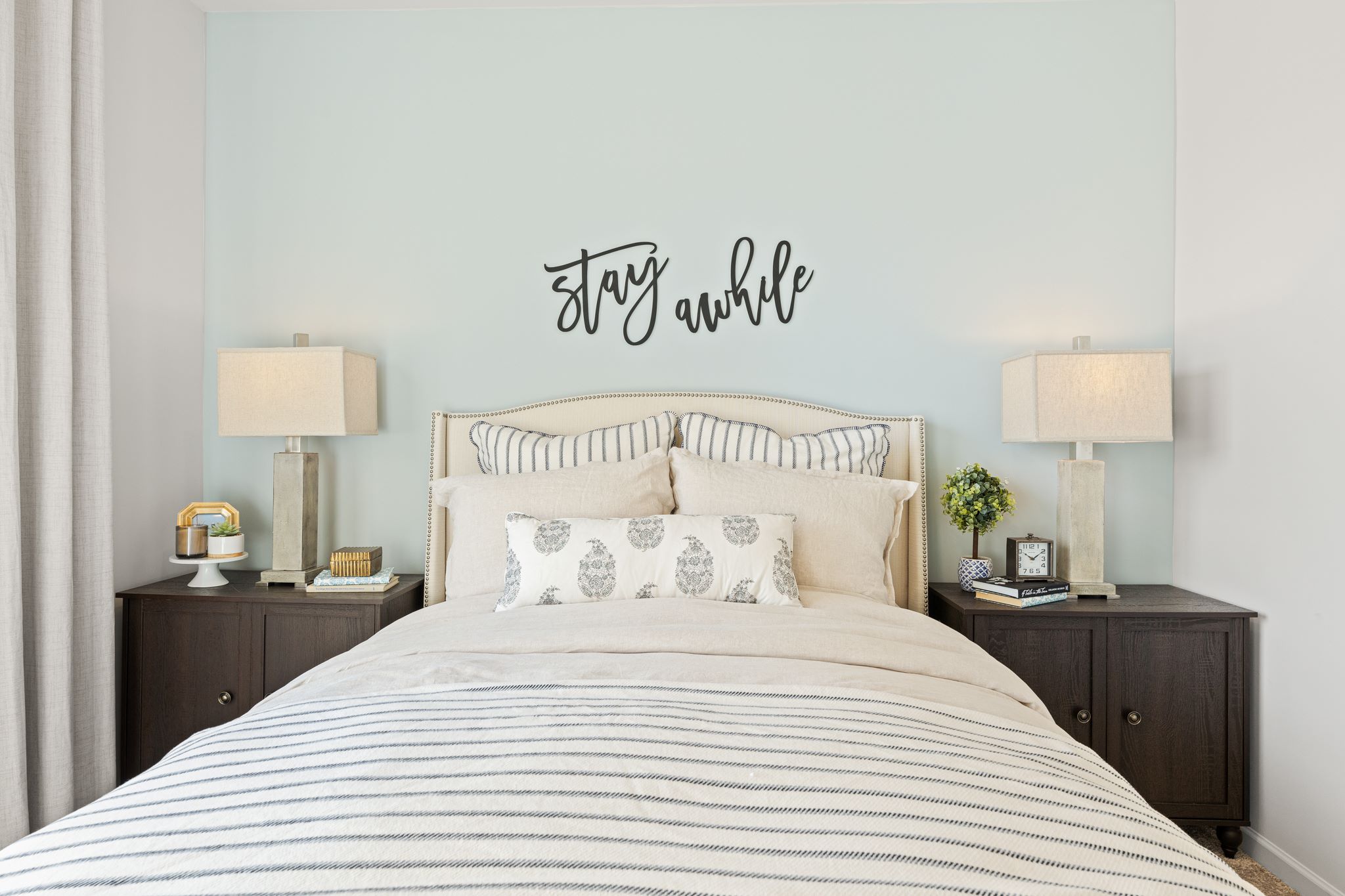 A bed with a white bed spread.