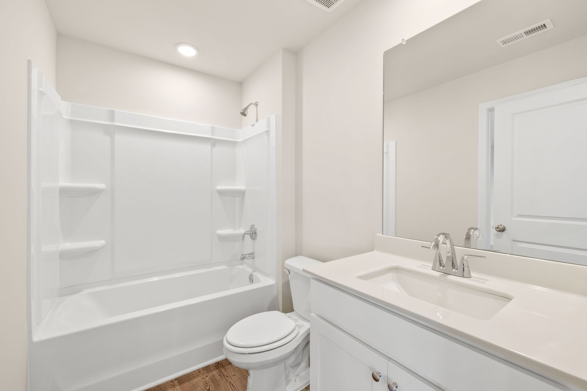 A bathroom with a tub sink and toilet.