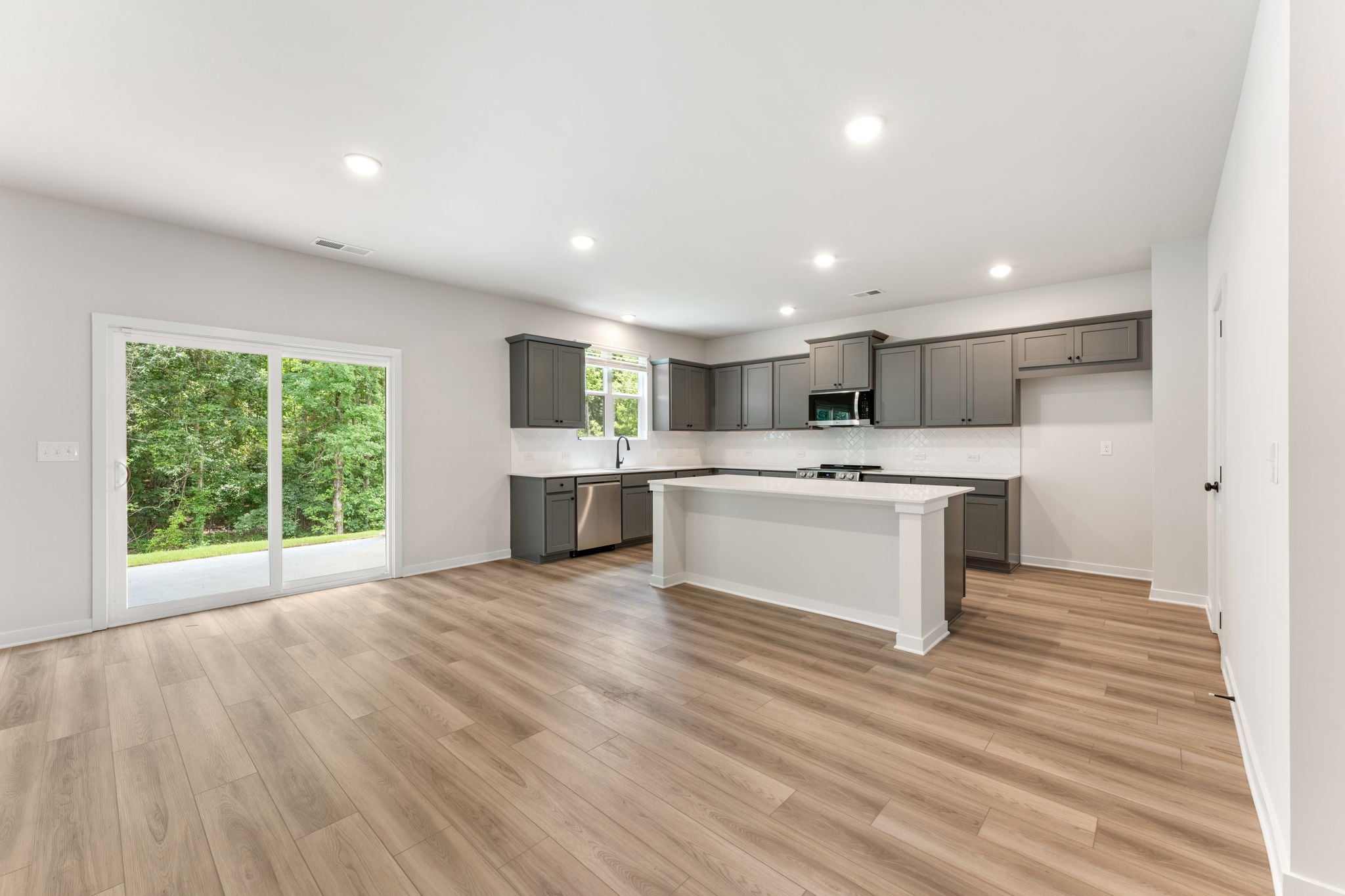 A kitchen with a wood floor.
