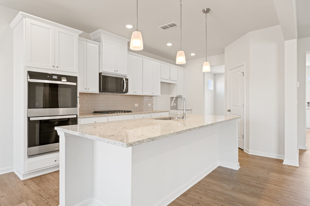 A kitchen with white cabinets.