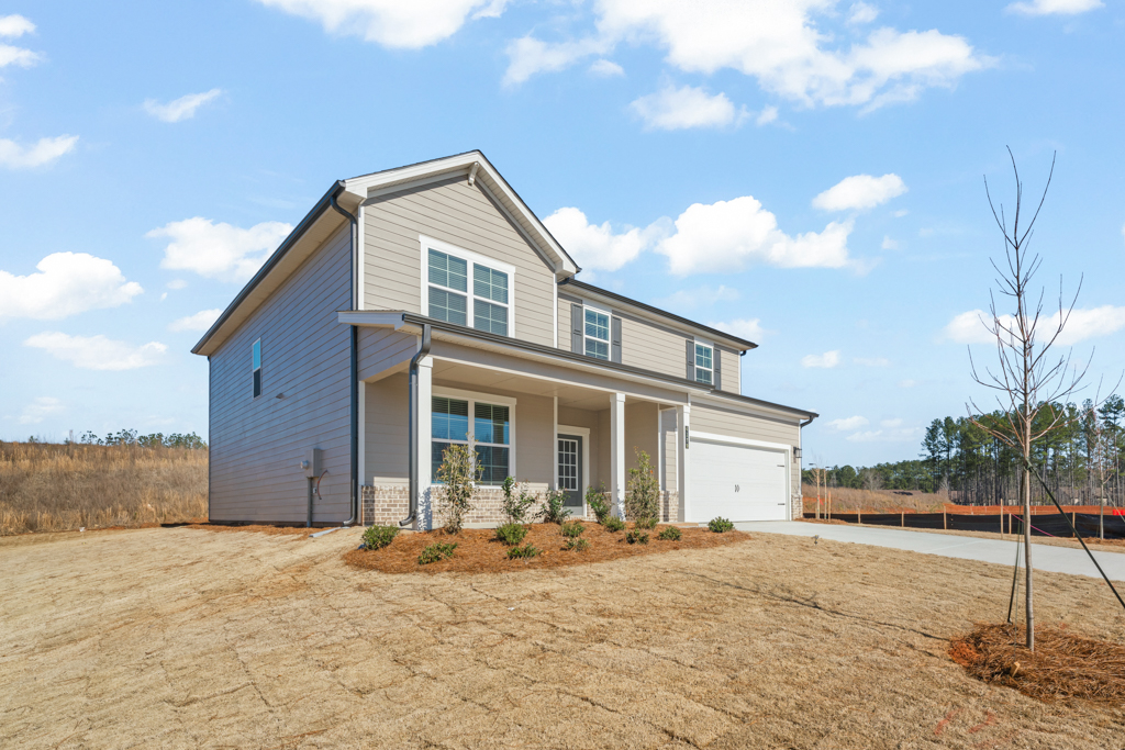 A house with a dirt lot.