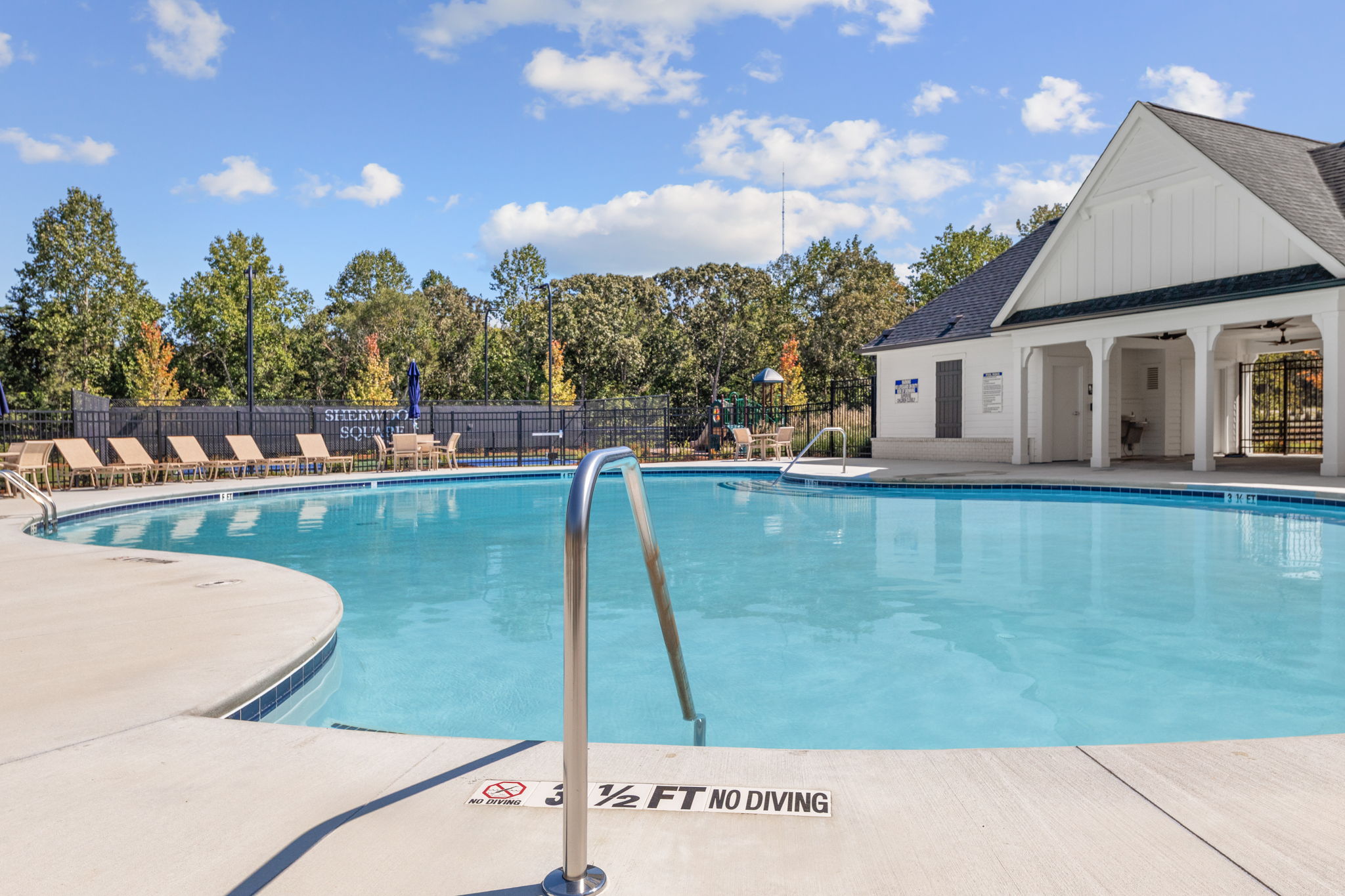 A swimming pool with a building in the background.