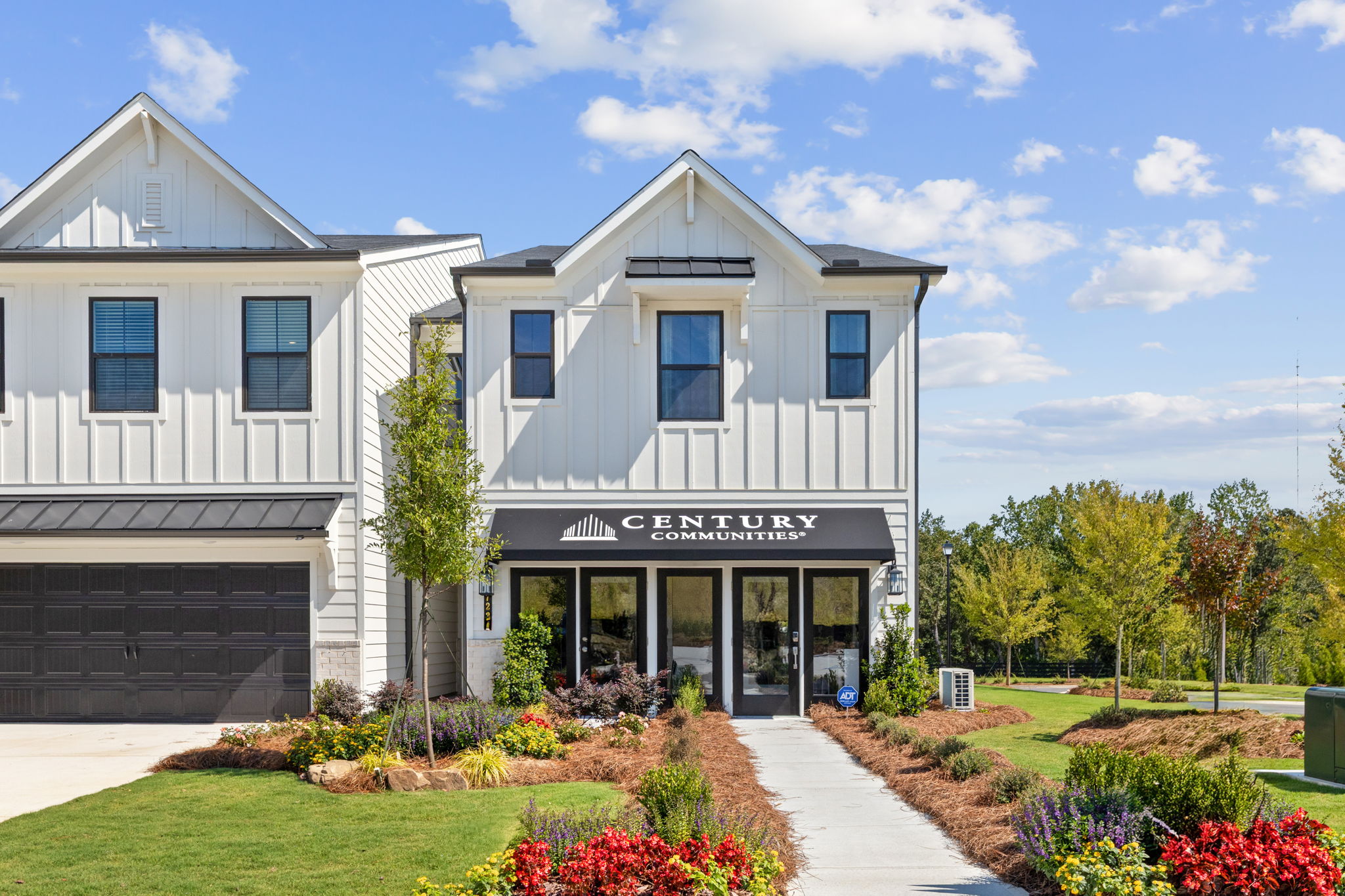 A white building with a sign on it.