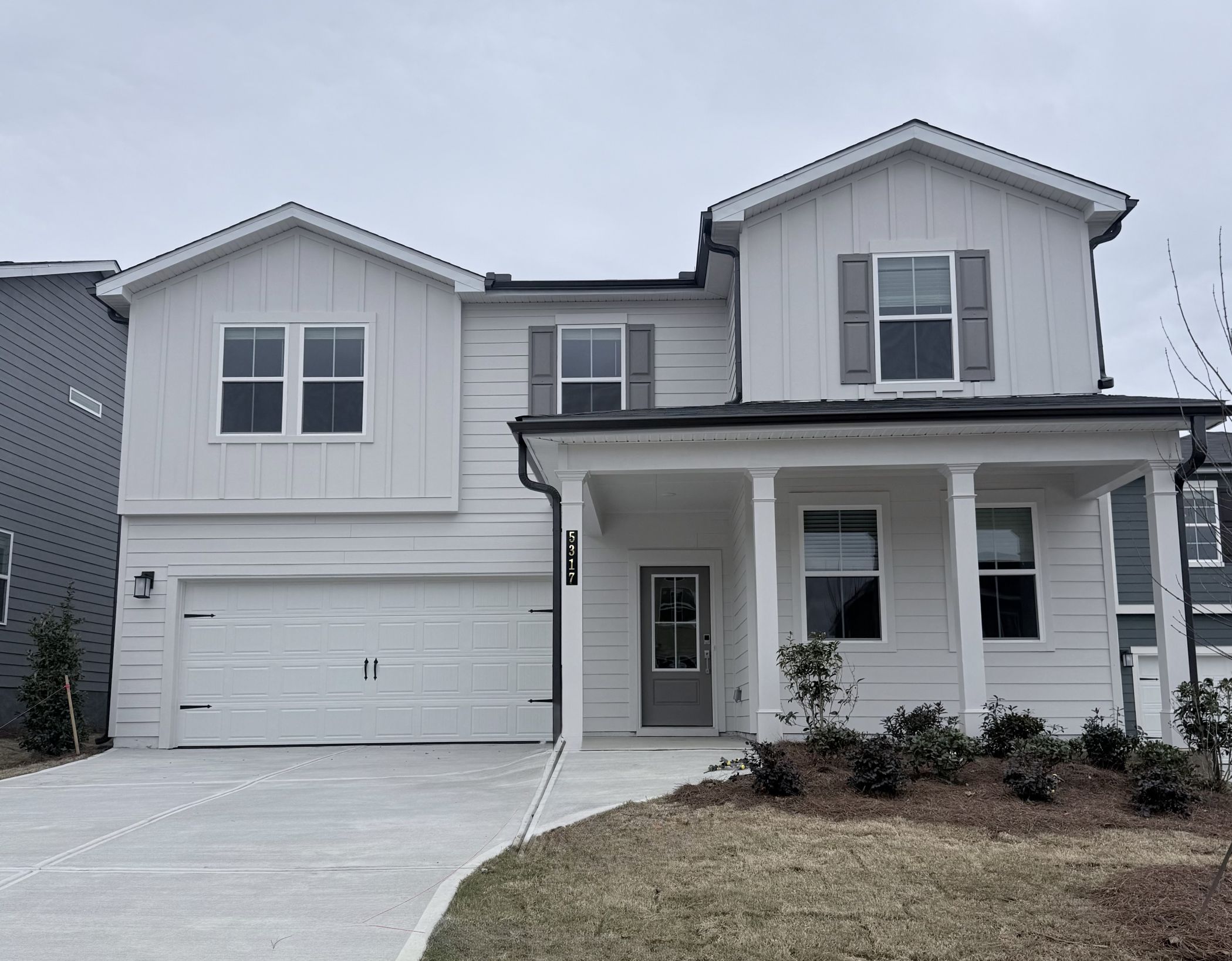 A white house with a garage.