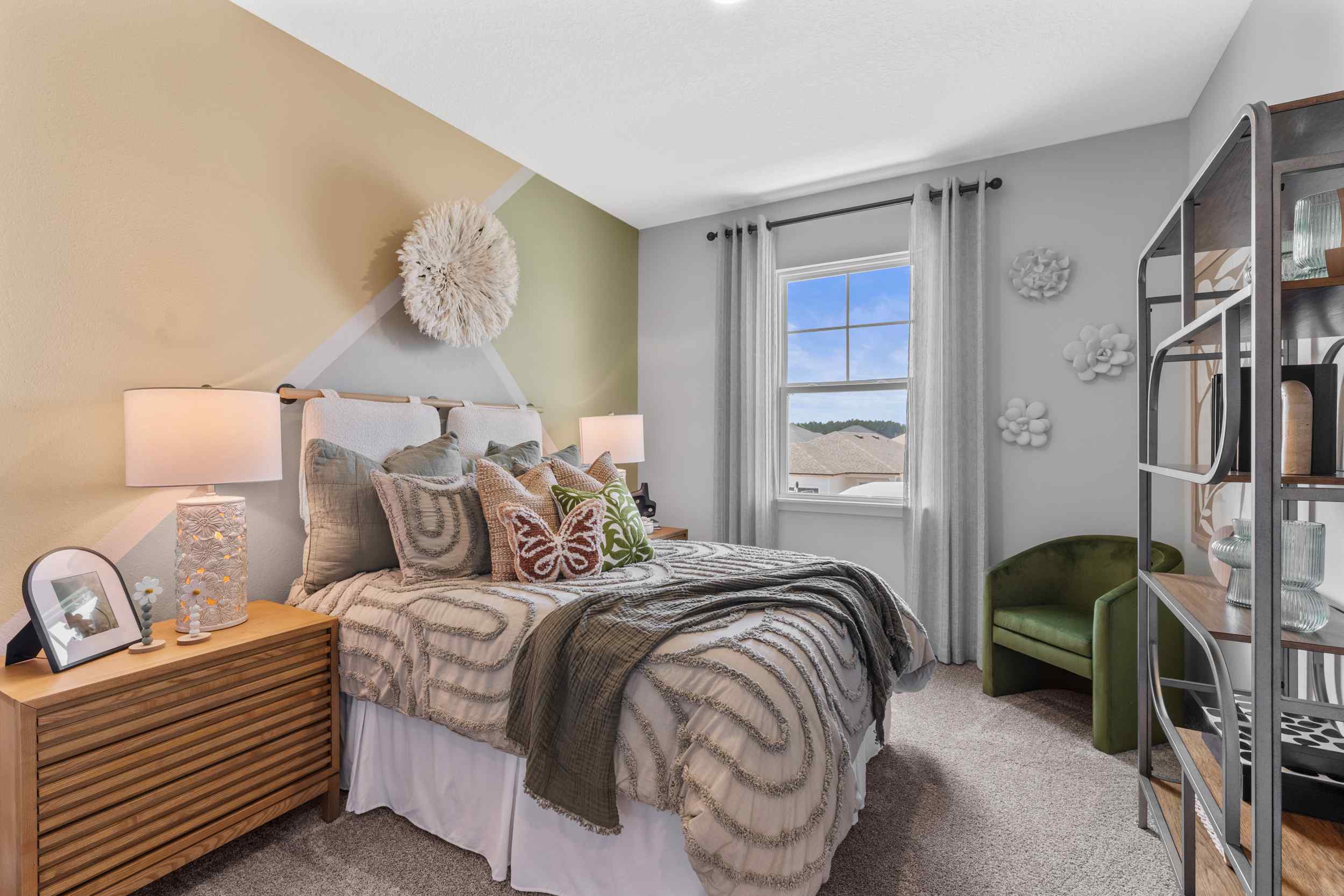 Silverbell II Model Home Guest Room with Bed and Open Shelving Unit at Camden Woods in Kingsland, GA