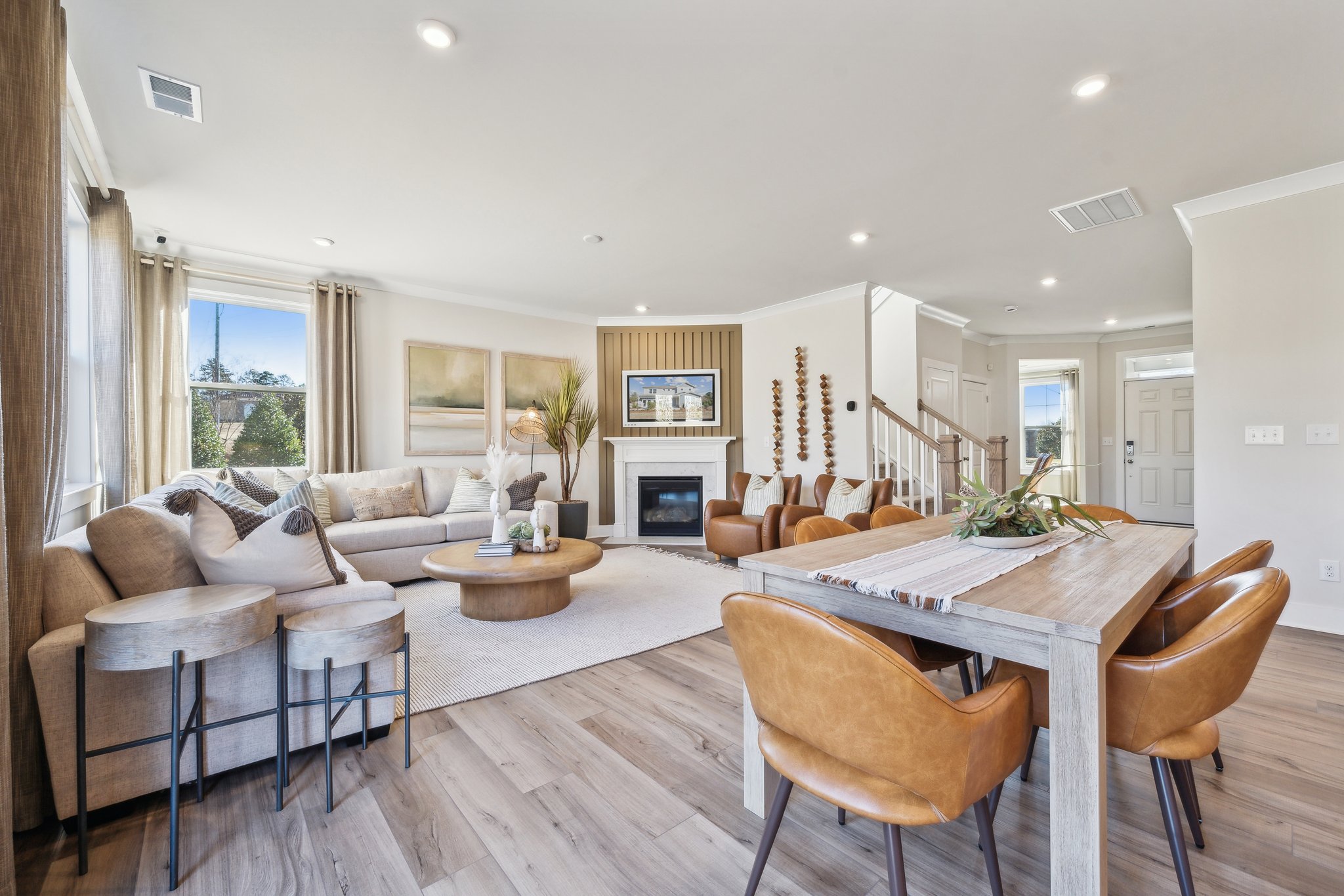 A large living room with a large dining table and chairs.
