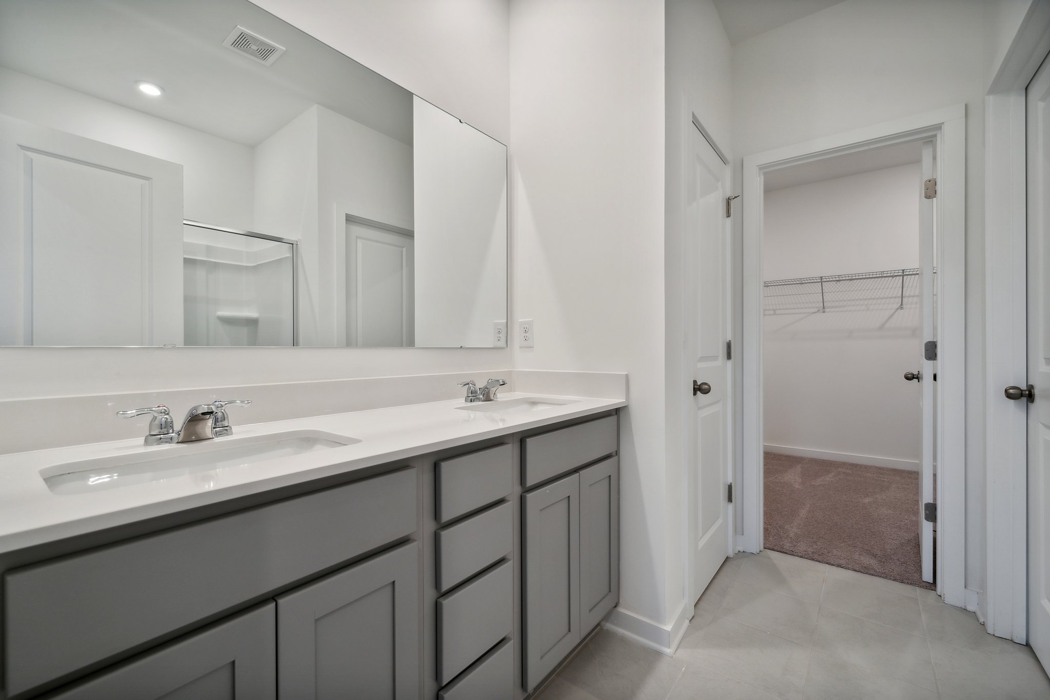 A bathroom with a sink and a shower.