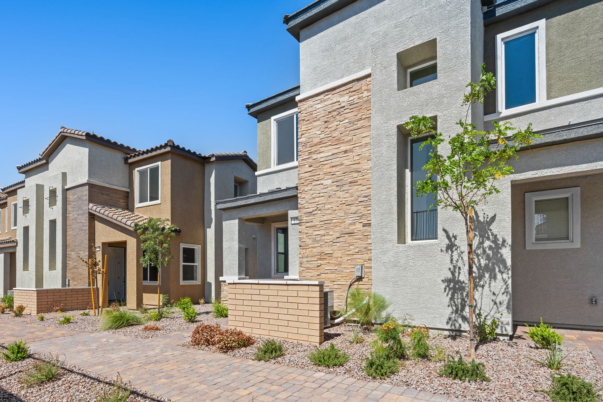 A brick building with a tree in front of it.