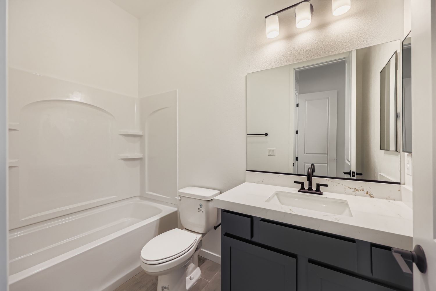 A bathroom with a tub sink and toilet.