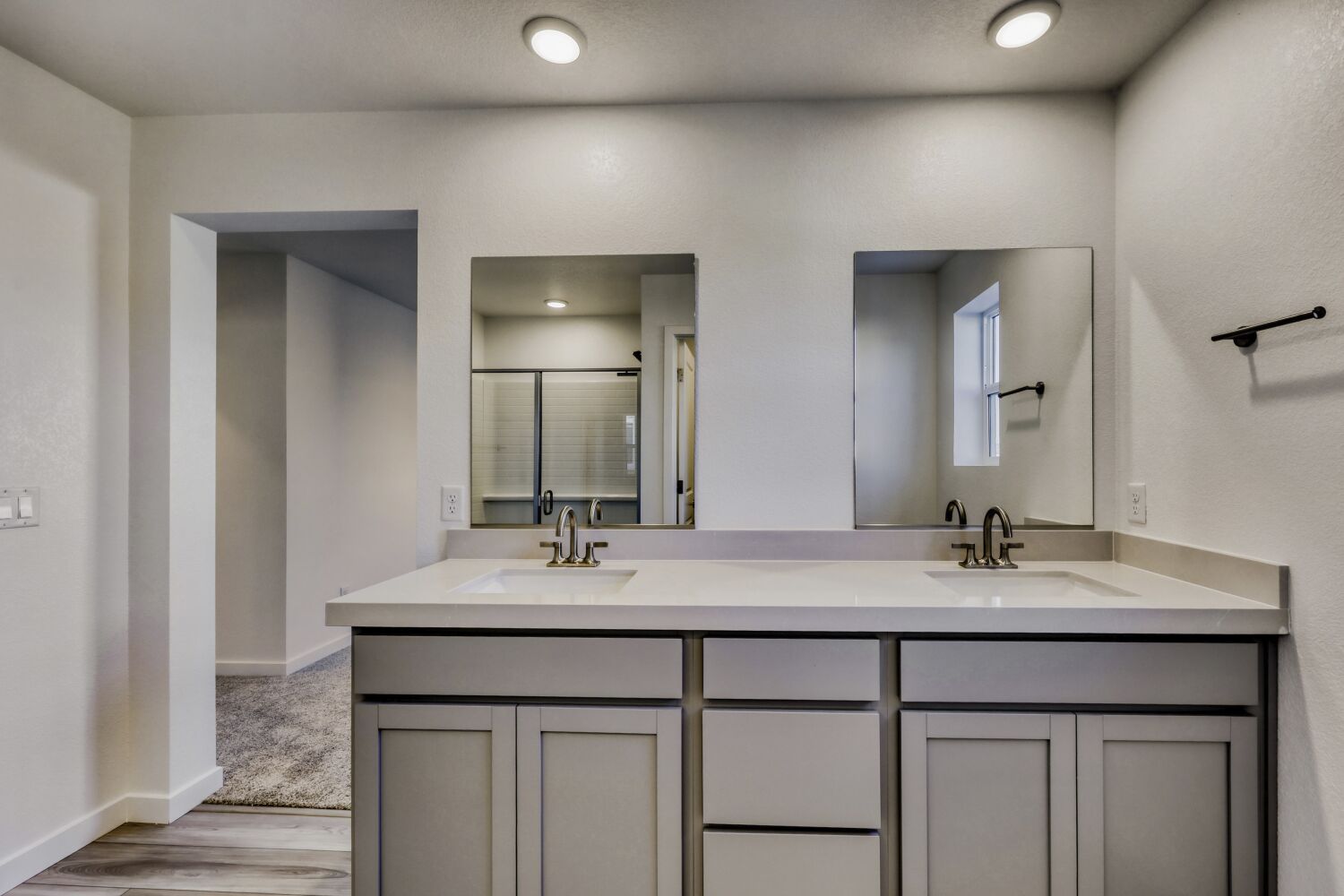 A bathroom with a large mirror.