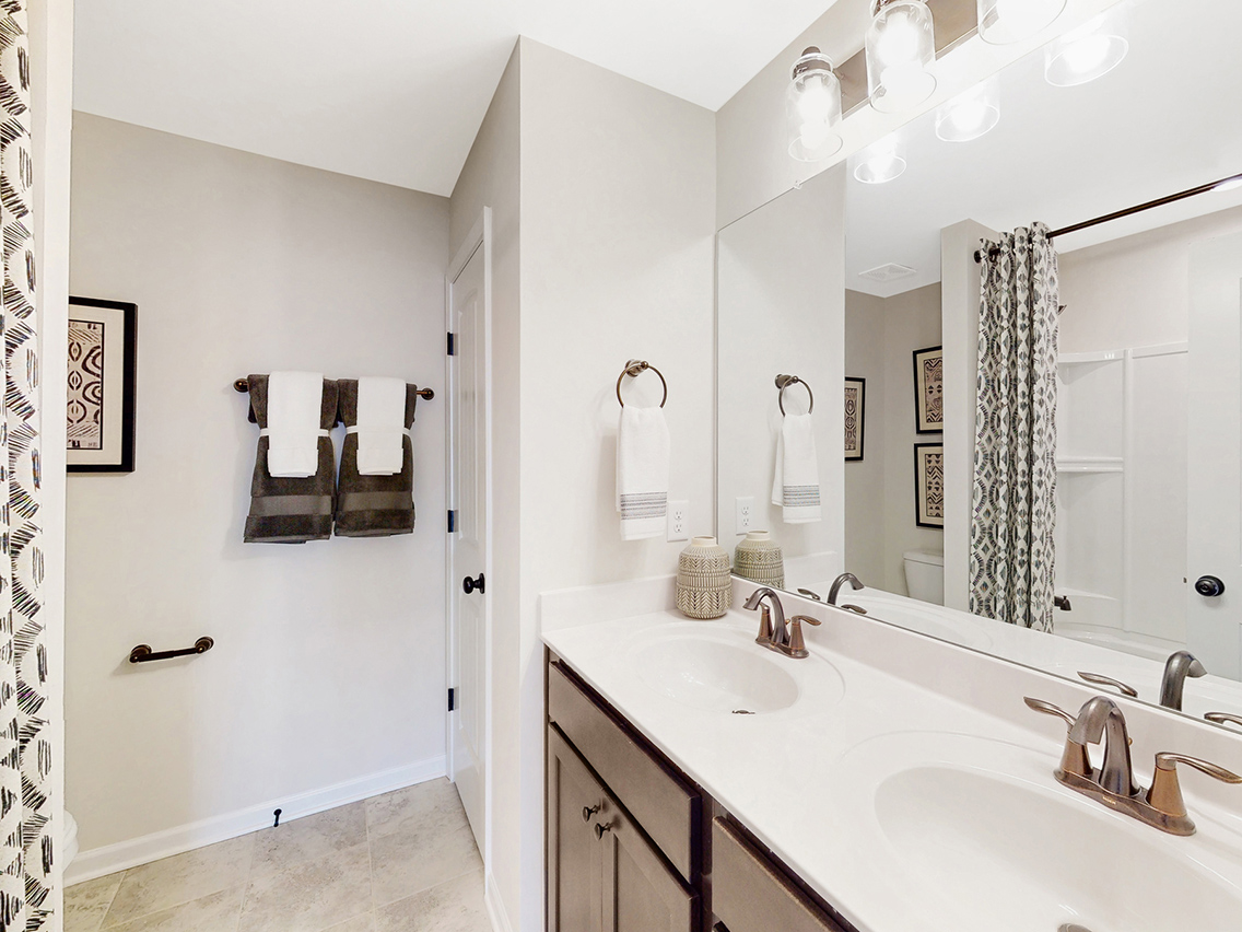 A bathroom with a large mirror.