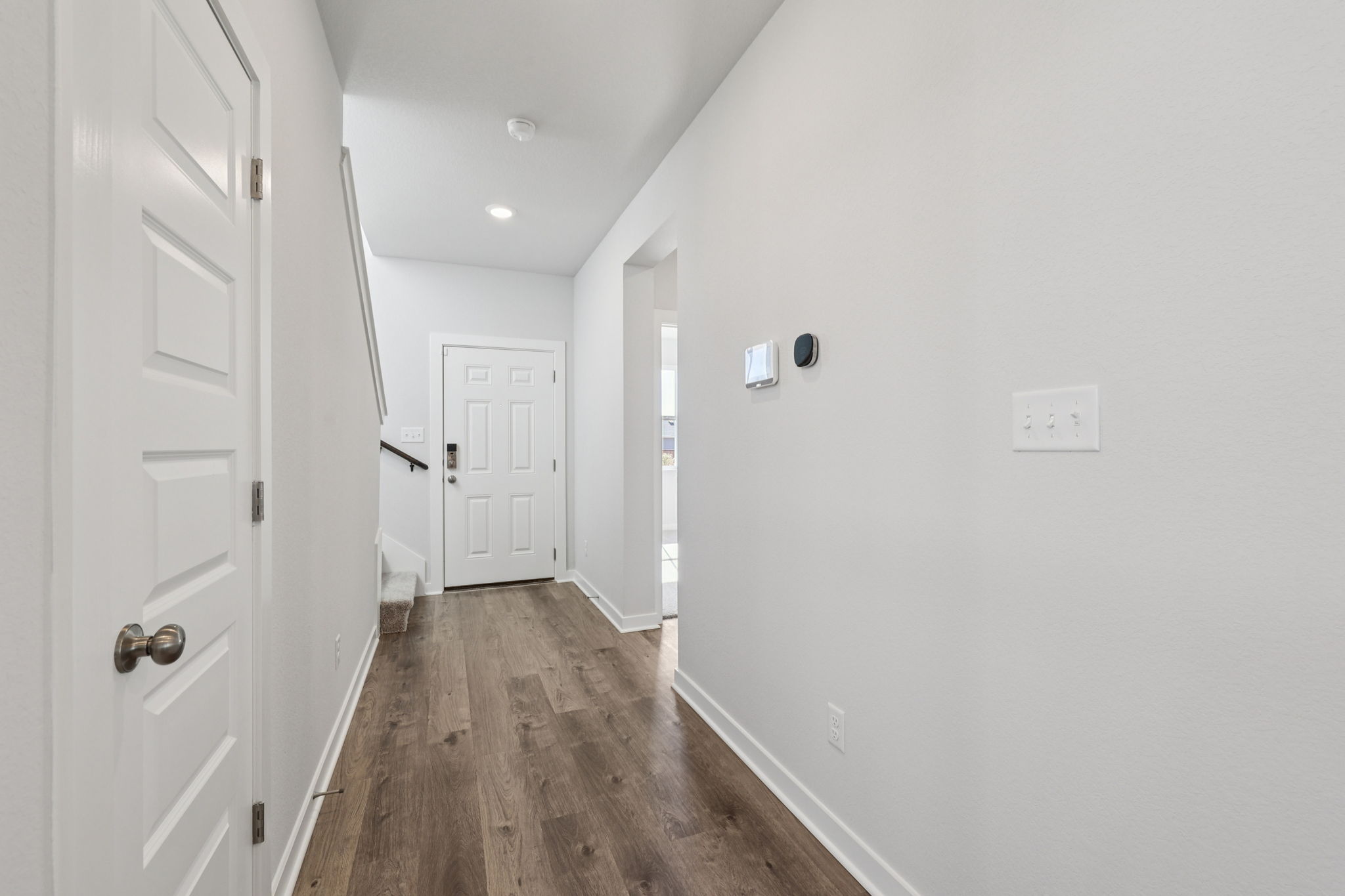 A hallway with white doors.