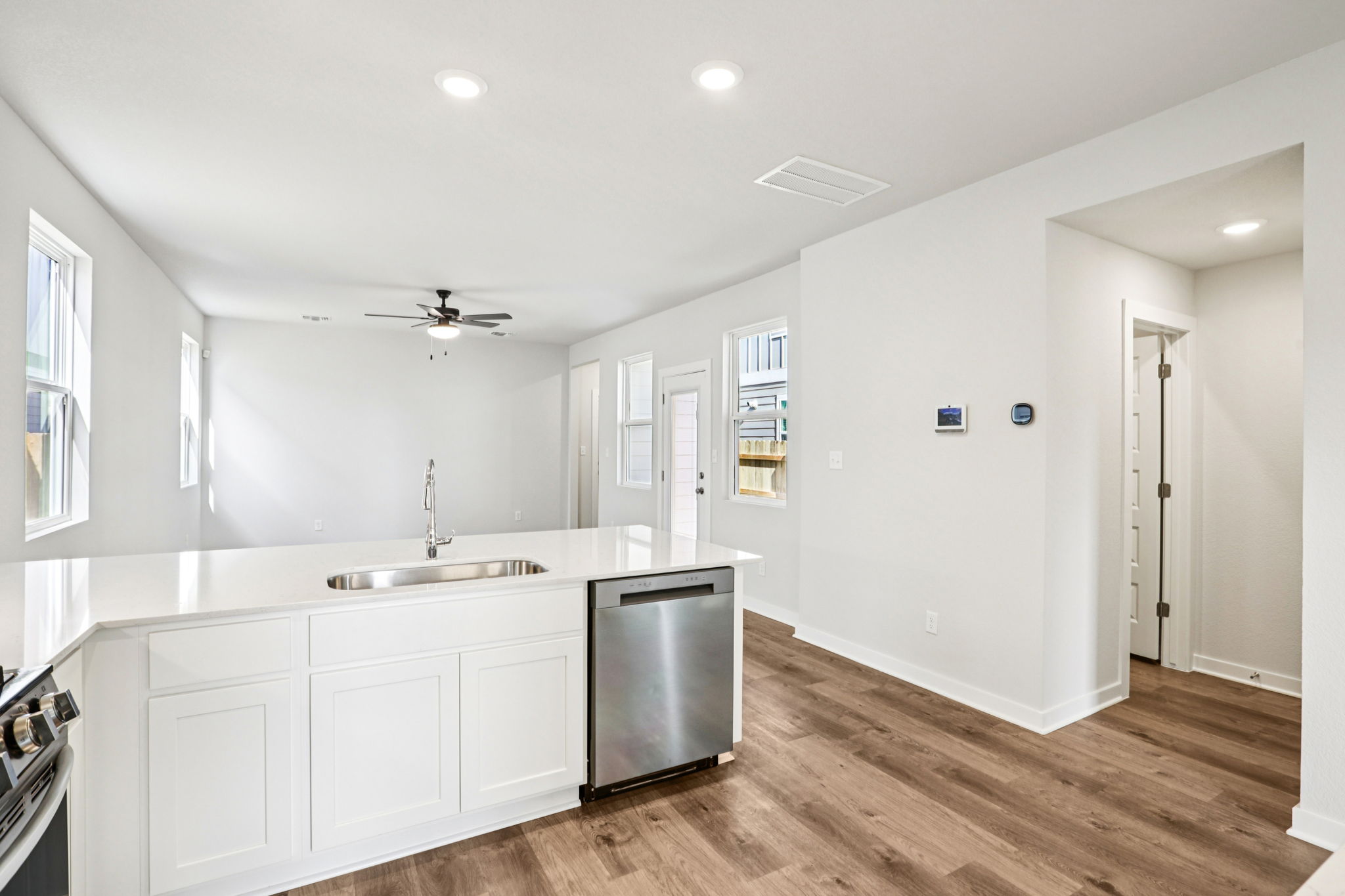 A kitchen with white cabinets.