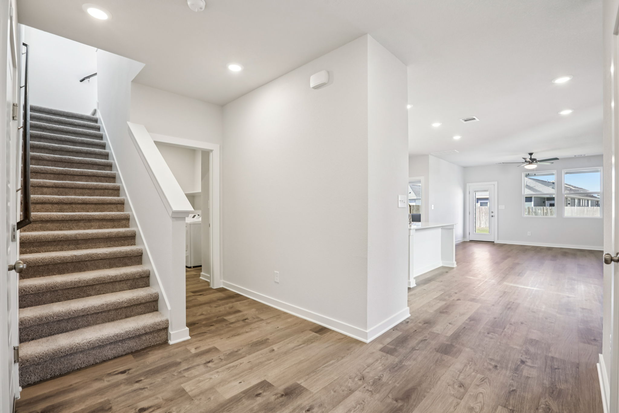 A large room with a wood floor and white walls.