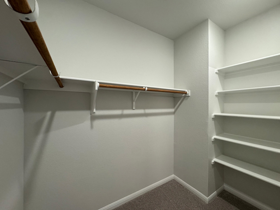 A white wall with a wooden railing.