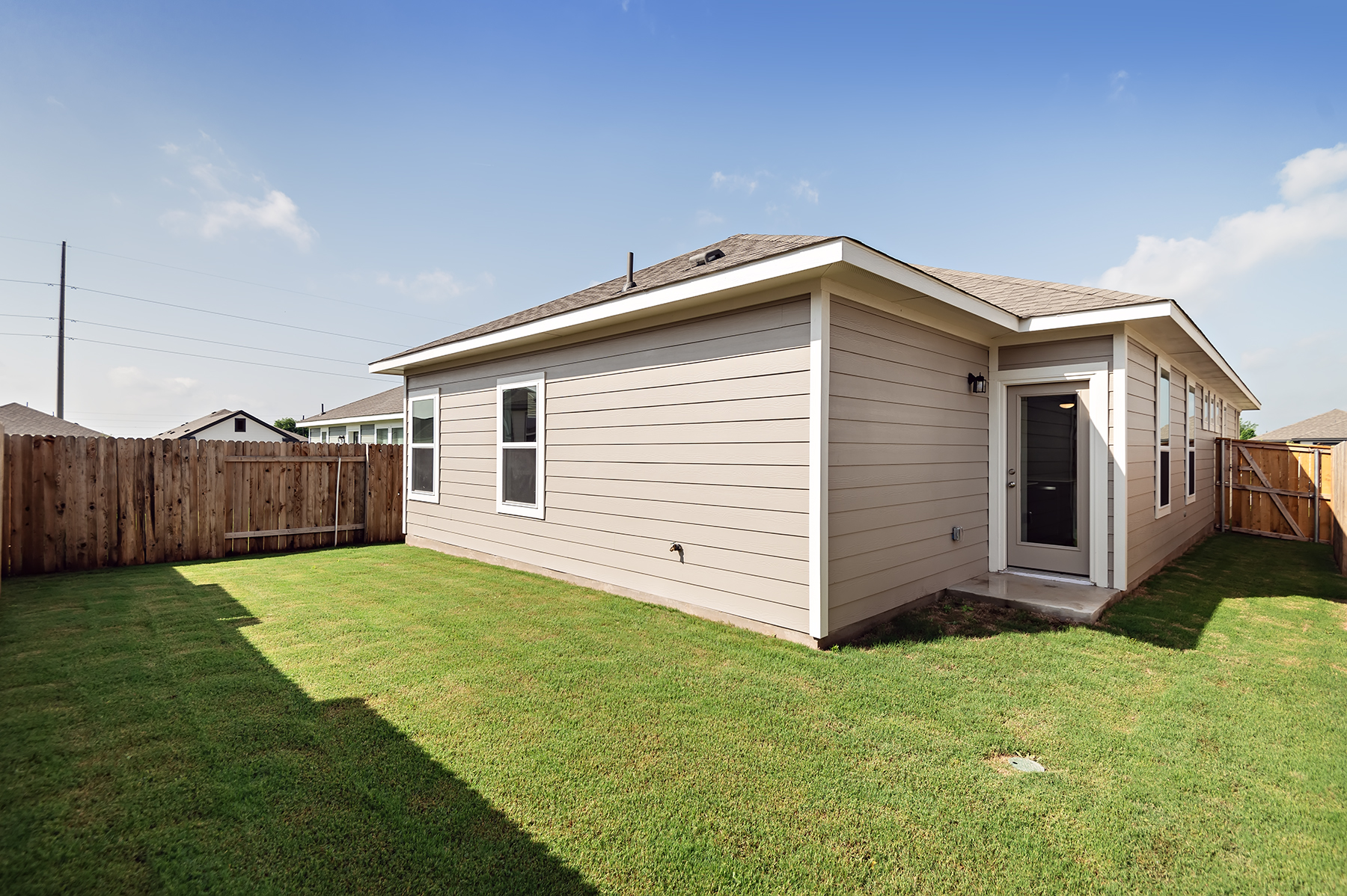 A small house with a fence.