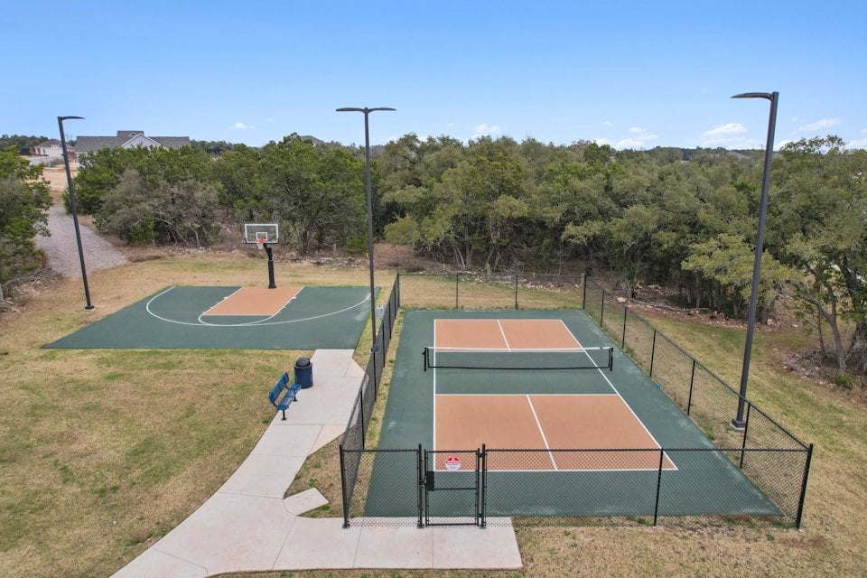 A tennis court with a fence.