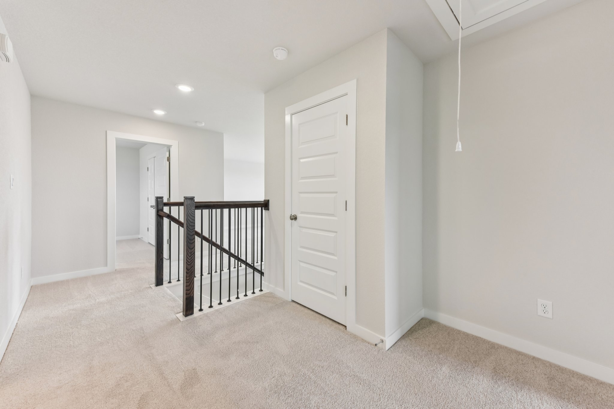 A hallway with white doors.