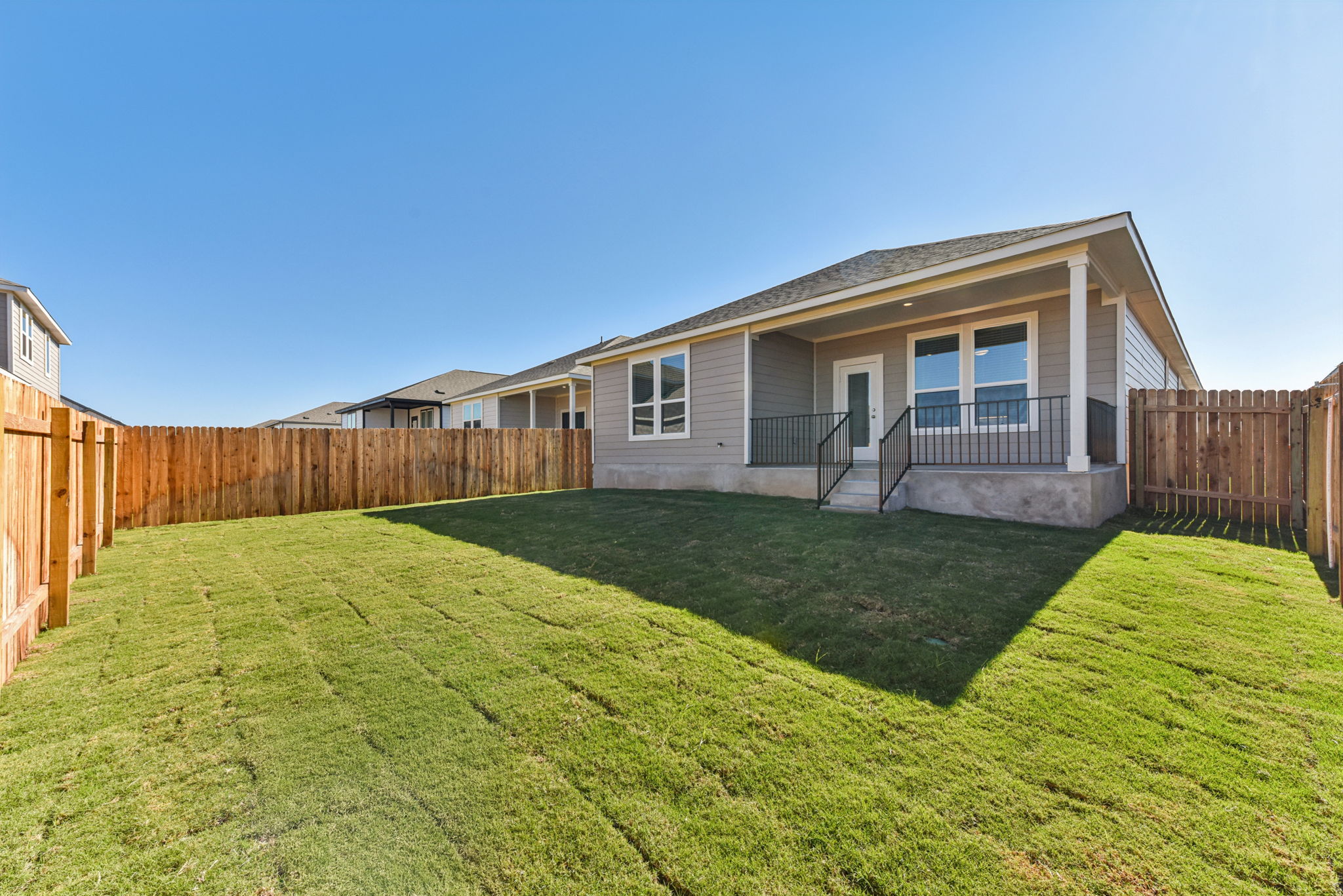 A house with a fence and grass.