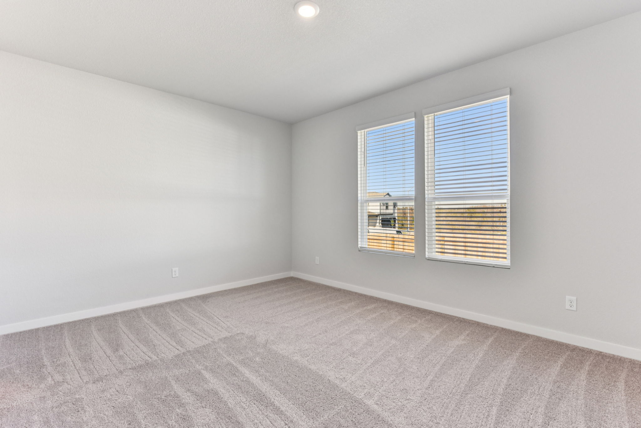 A room with a window and a carpet.