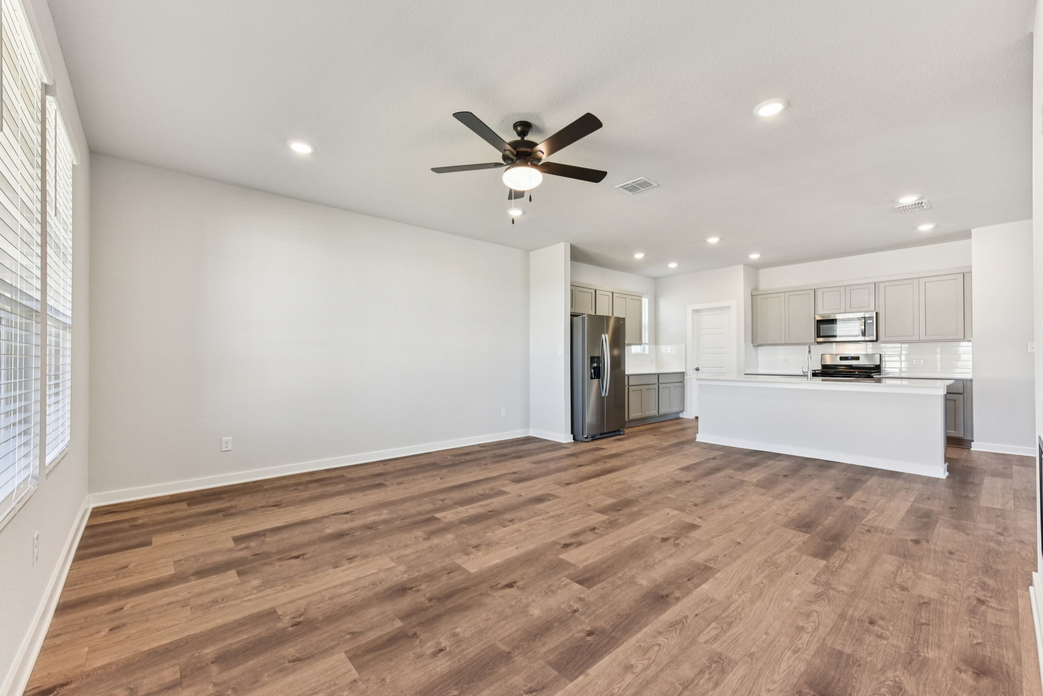 A kitchen with white cabinets.