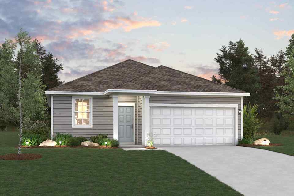 A house with a garage and a lawn in front of it.