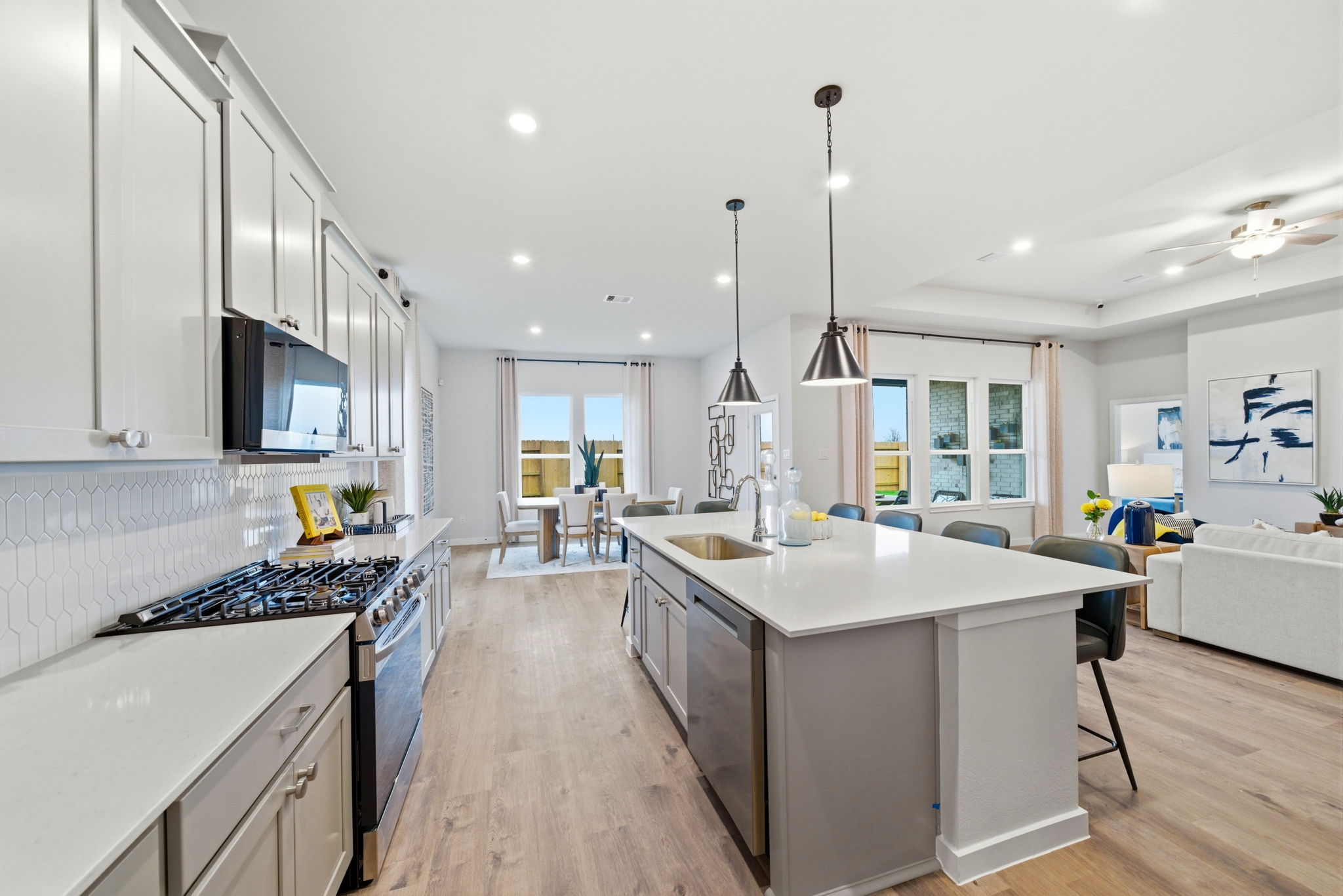 A kitchen with white cabinets.