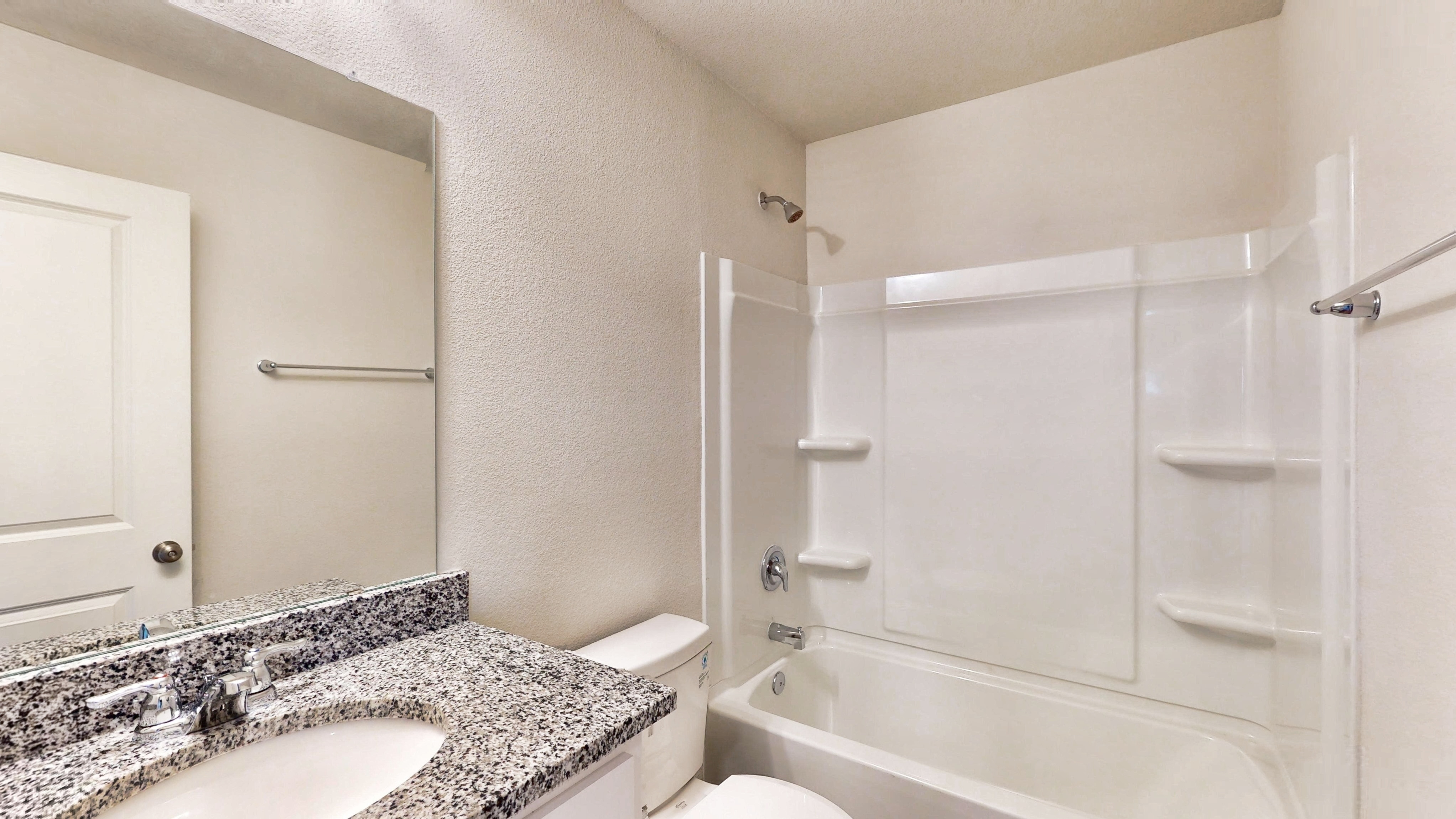 A bathroom with a marble countertop.