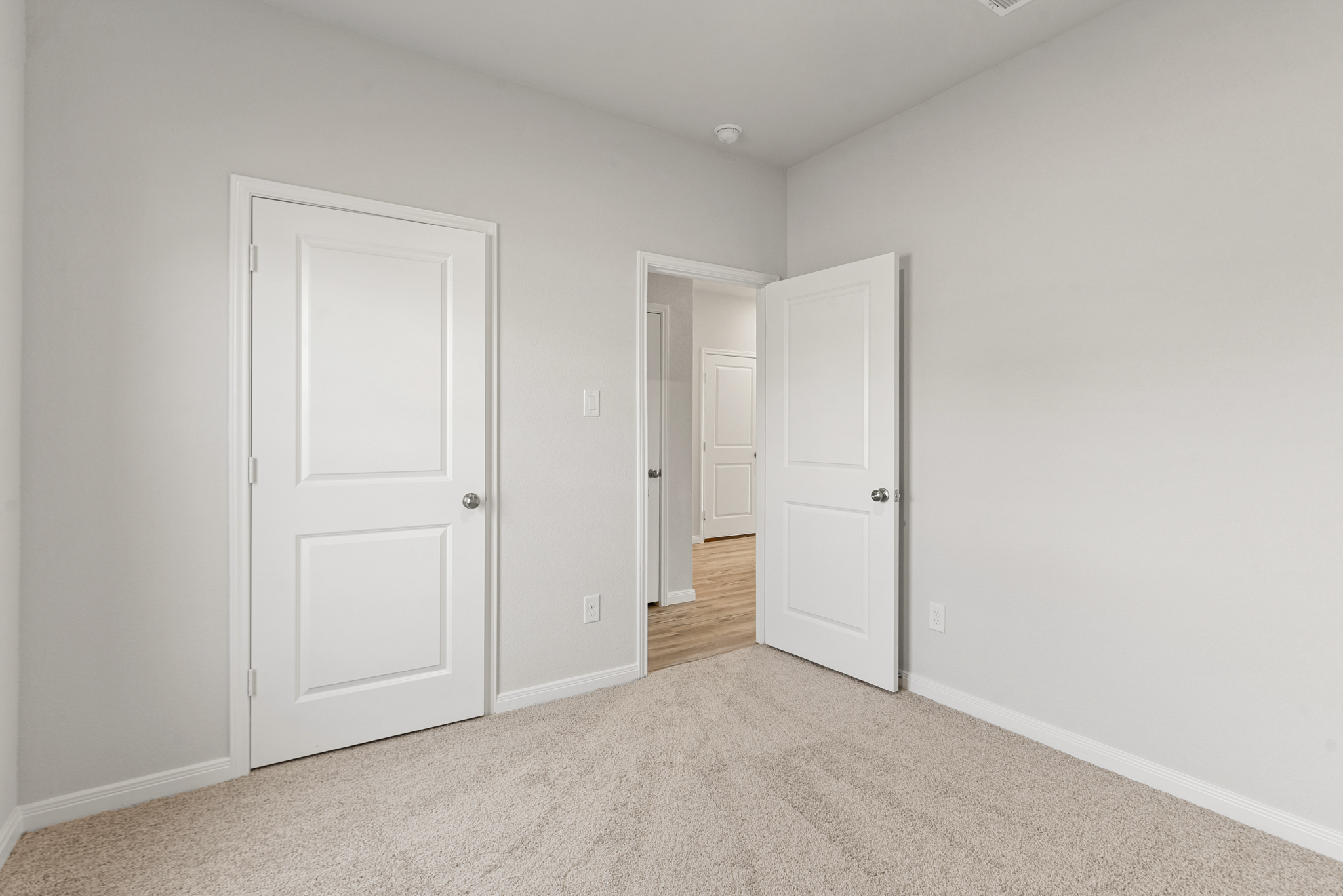 A hallway with white doors.