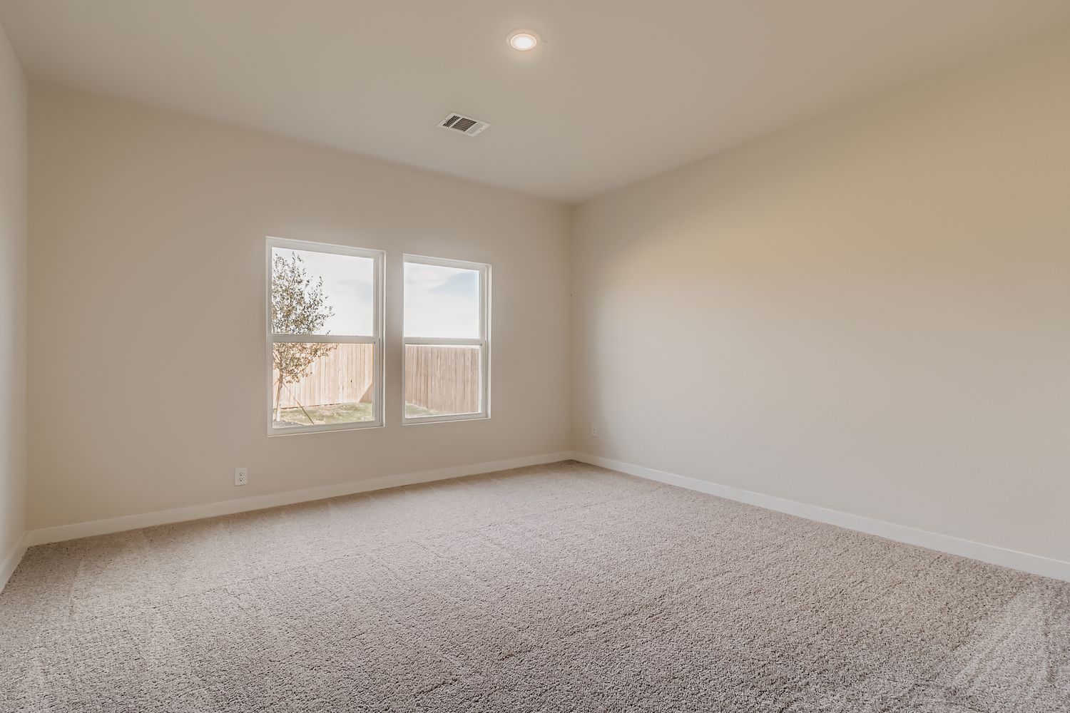 A room with a window and carpet.