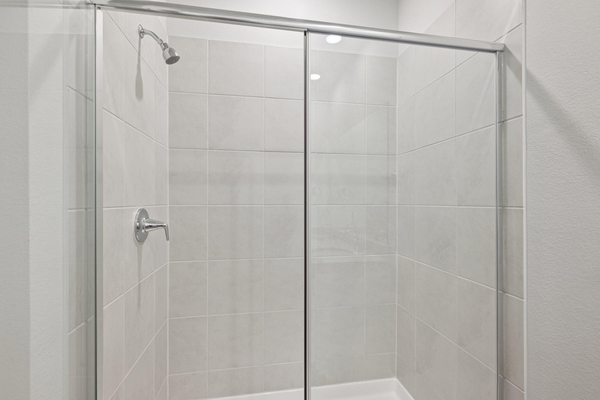 A shower with a glass door.