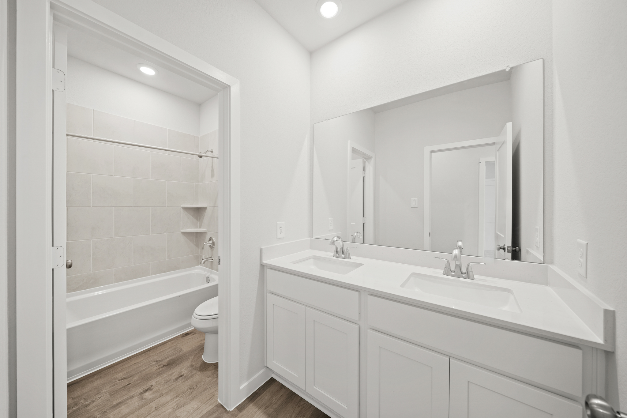 A bathroom with a tub sink and toilet.