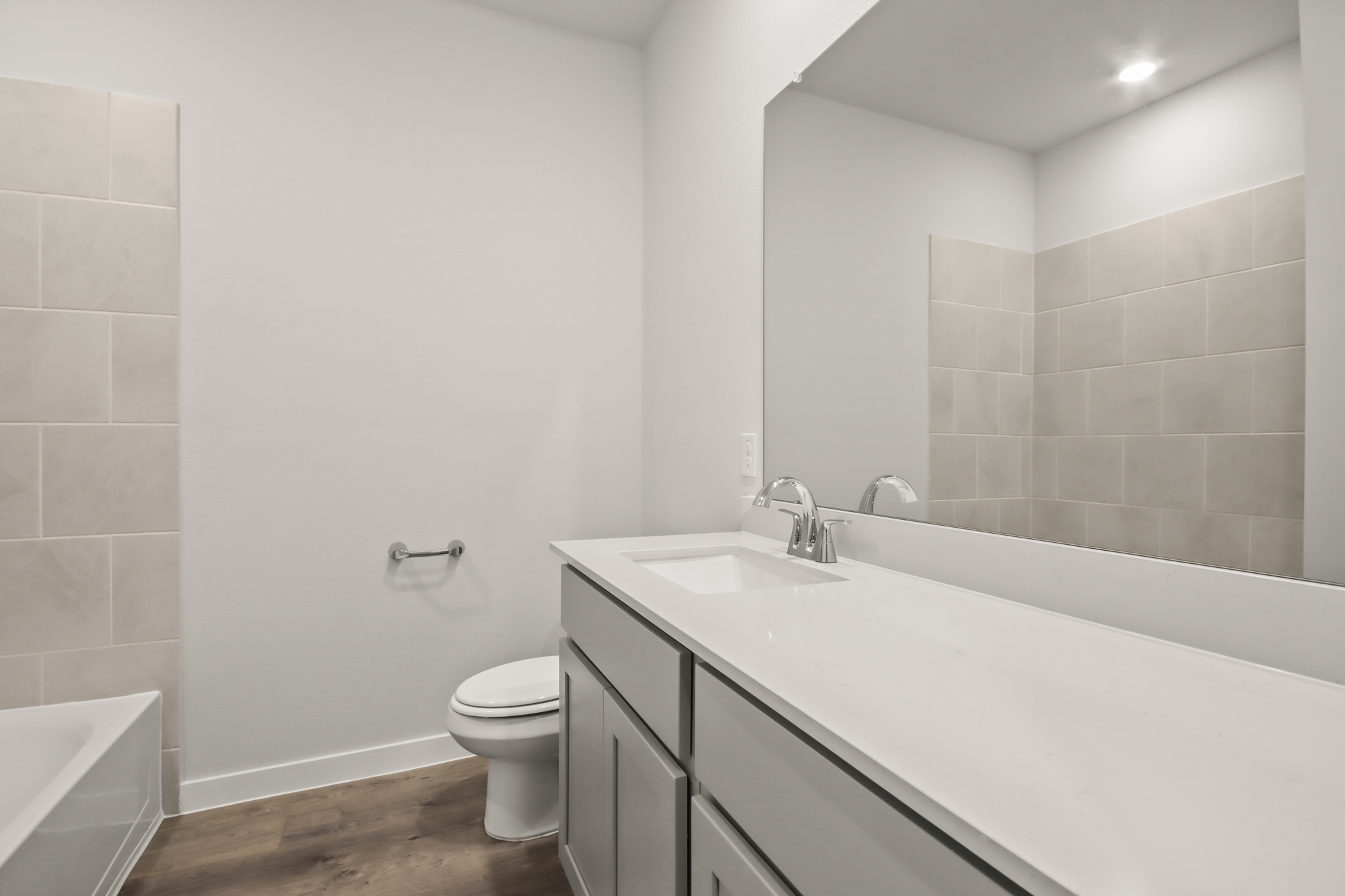 A bathroom with a tub sink and toilet.