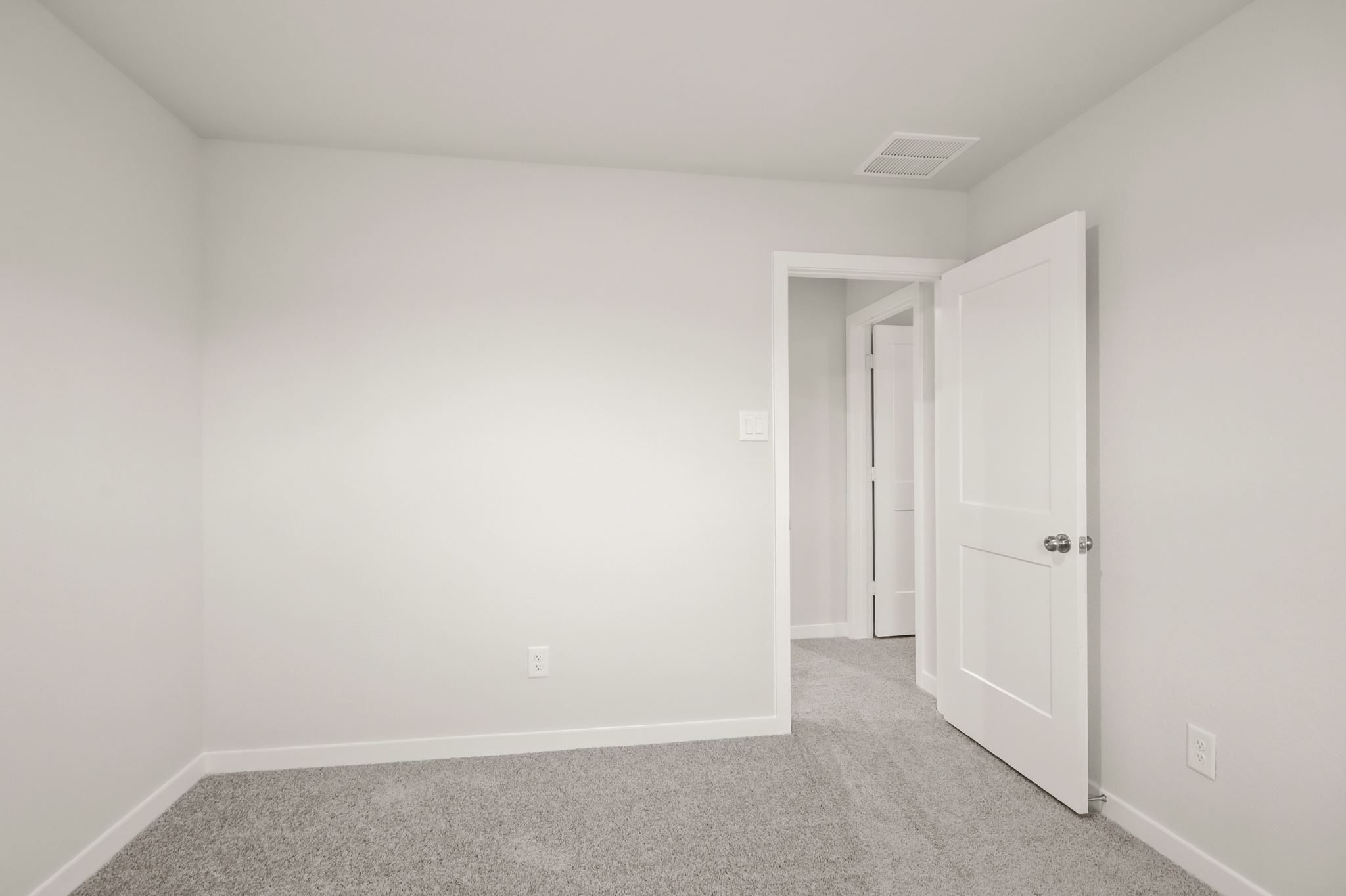 A hallway with white doors.